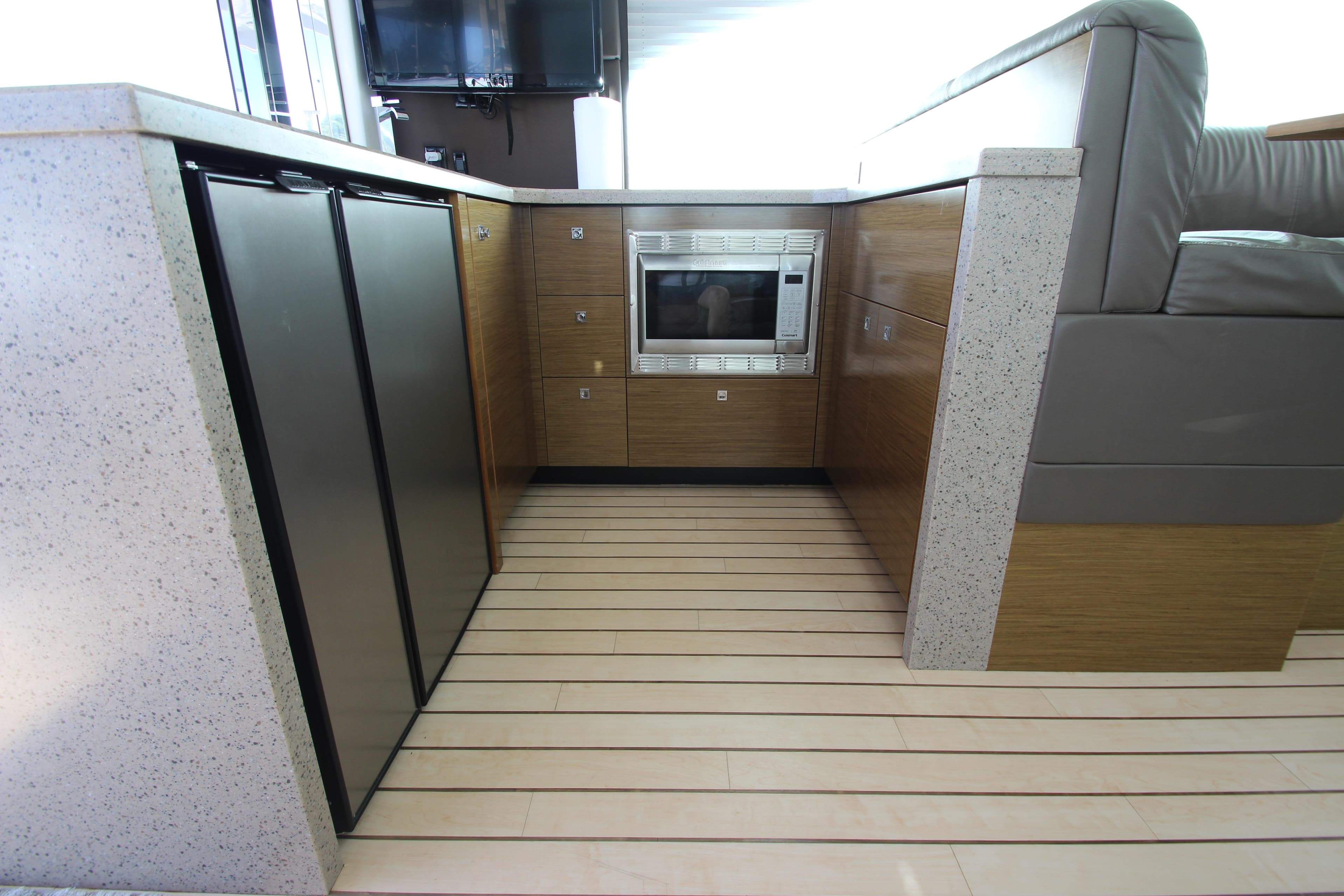 Modern kitchen area in 2014 Cruisers Yachts 45 Cantius with sleek appliances and wood flooring.