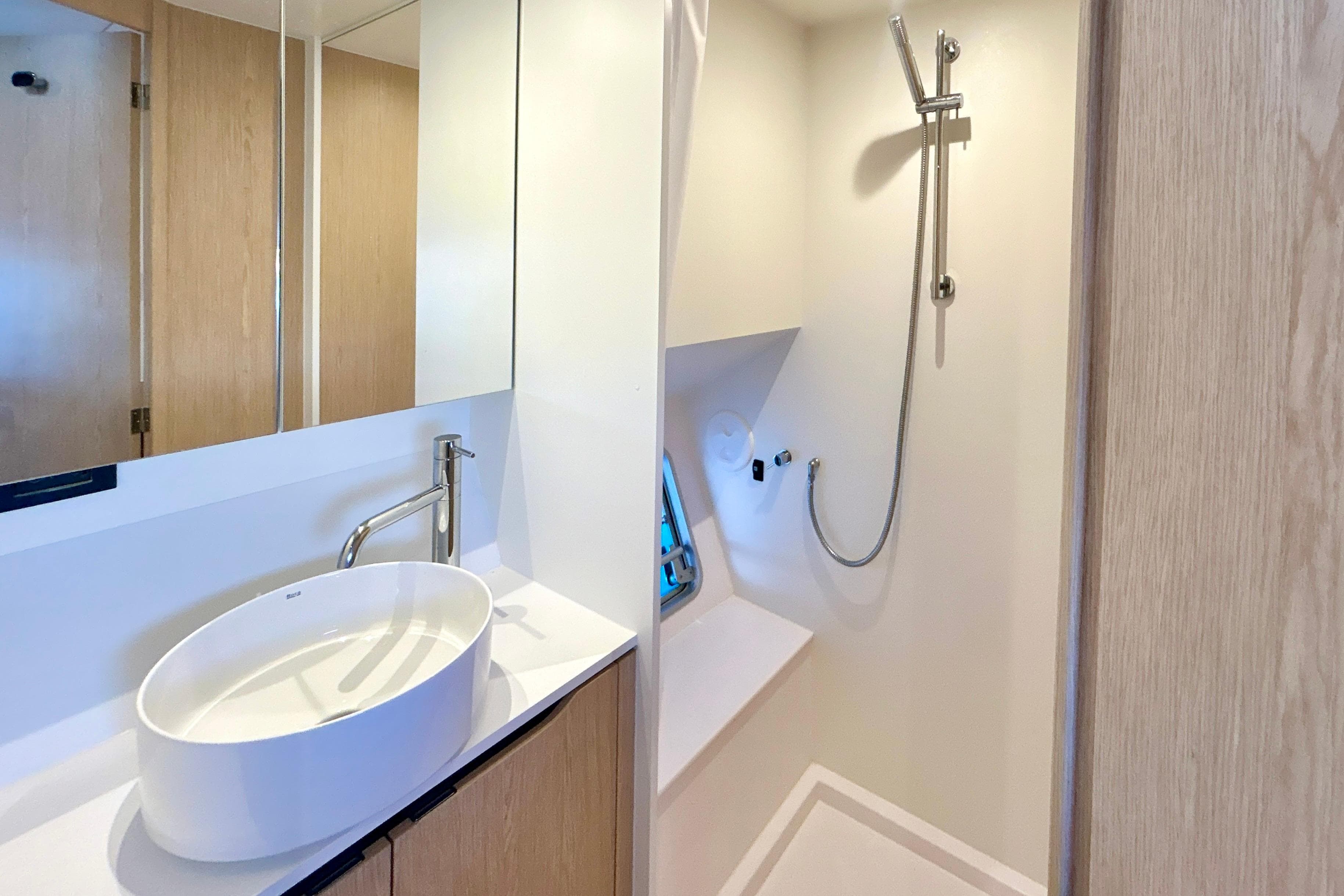 Modern bathroom interior of 2025 Outremer 55 yacht with sleek sink and shower.