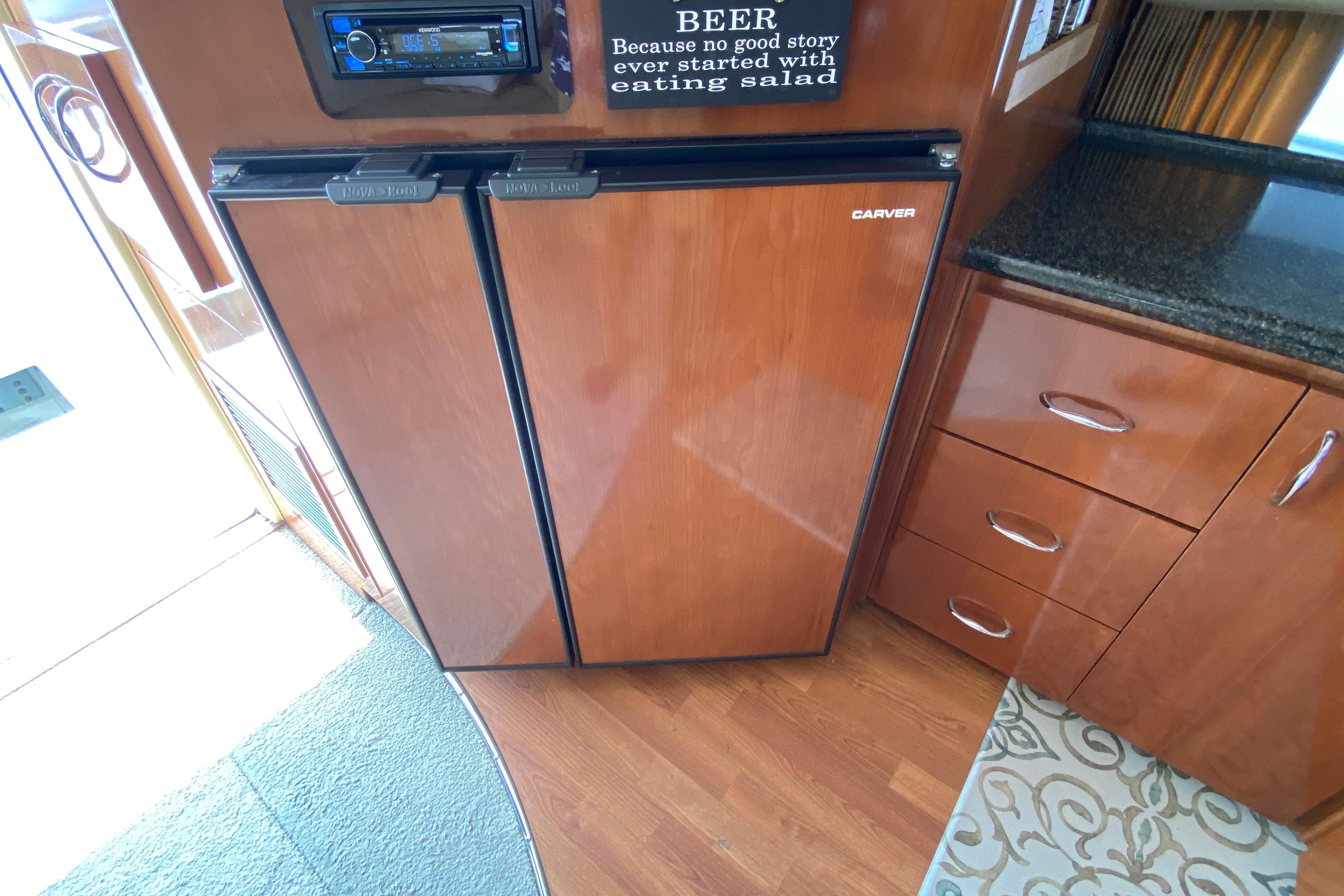 2004 Carver 36 Super Sport interior with wood cabinetry and built-in refrigerator.