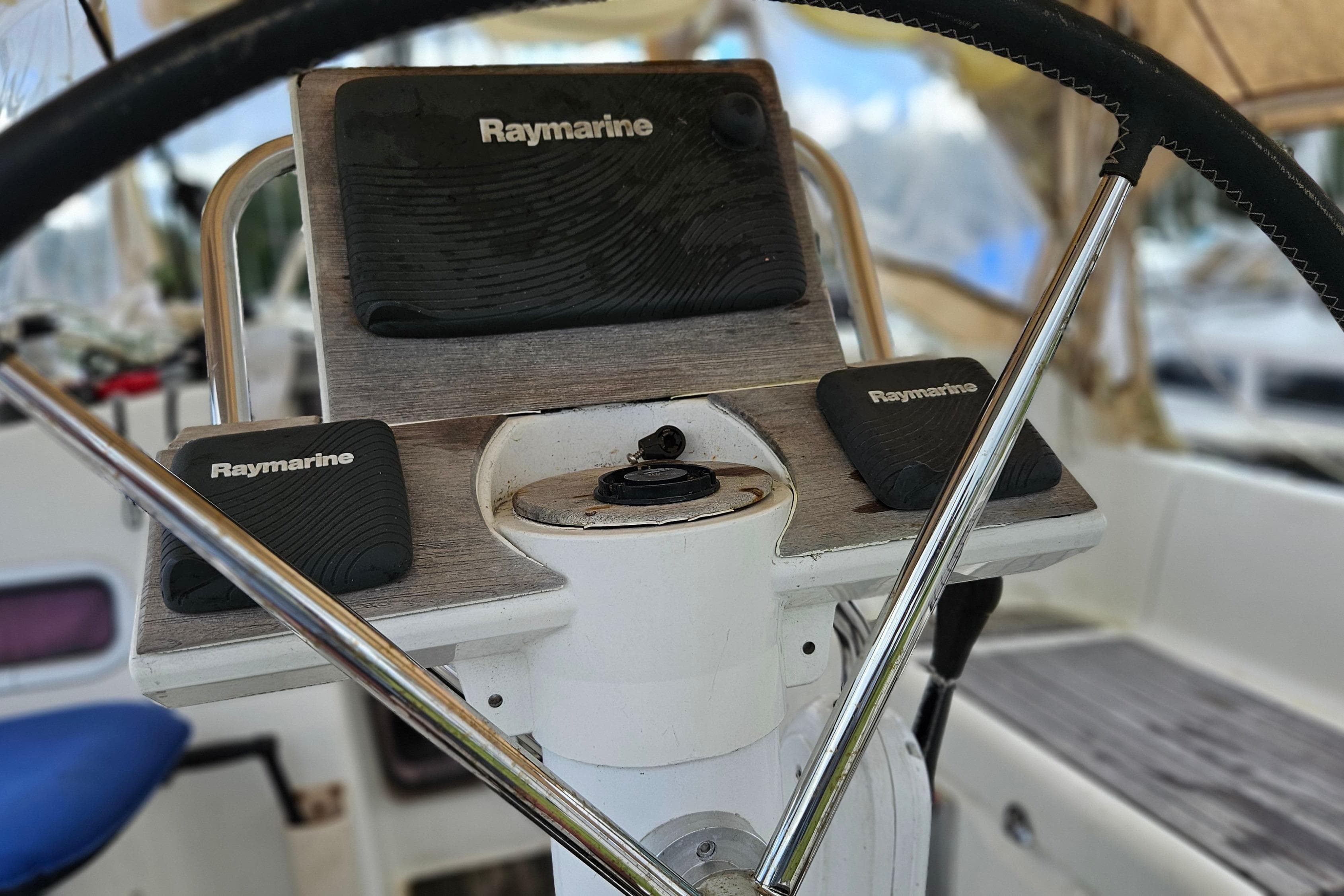 Steering wheel and Raymarine controls on 2010 Beneteau Oceanis 34 GT yacht.