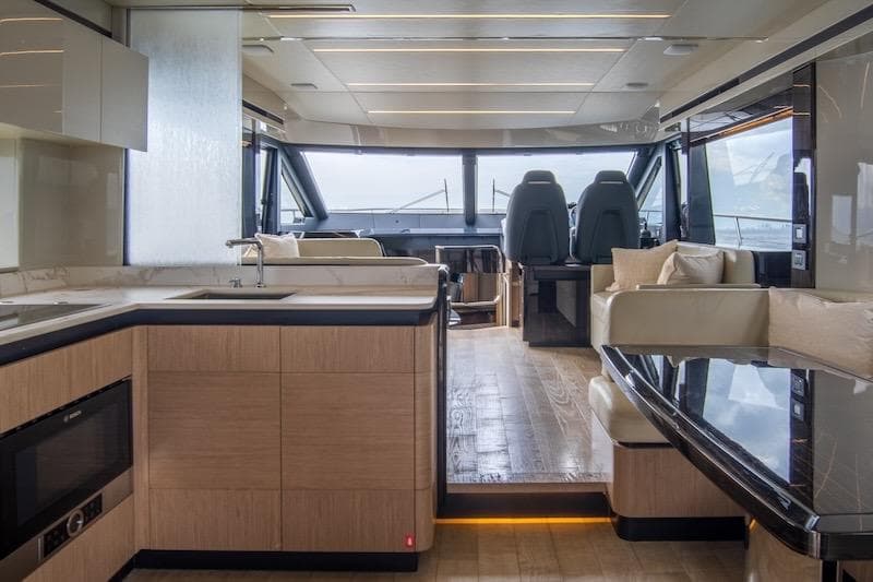 Luxurious interior of 2023 Absolute 62 Fly yacht with modern kitchen and seating area.