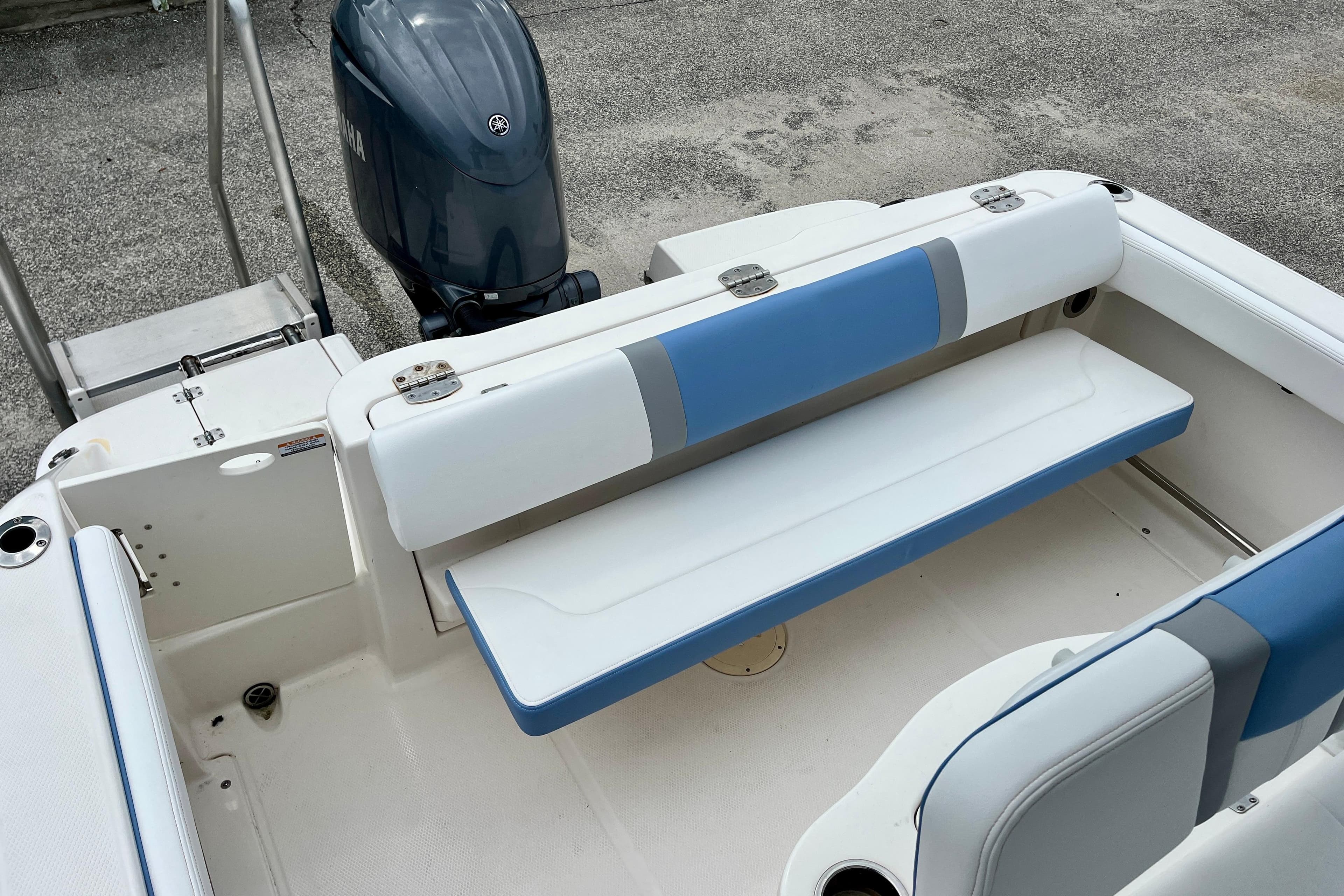 2024 Robalo R222 Center Console boat with blue and white seating and Yamaha outboard motor.