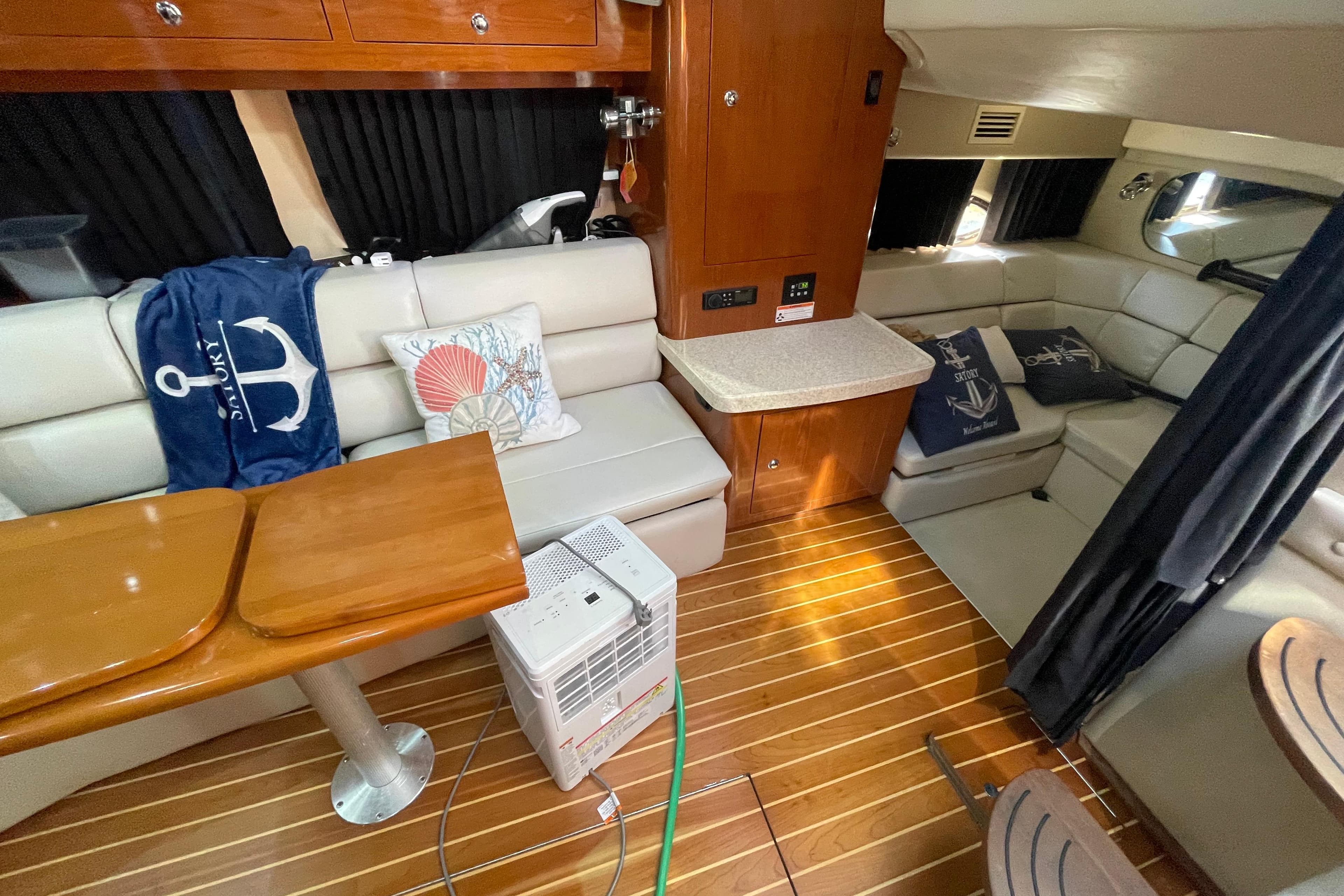 Interior of 2006 Regal Commodore 3560 IB yacht with cozy seating and nautical decor.