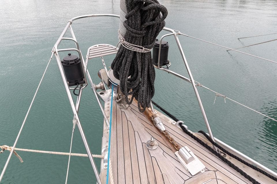 Bow of 1992 Nautor Swan 68 yacht with ropes and metal fittings on deck.