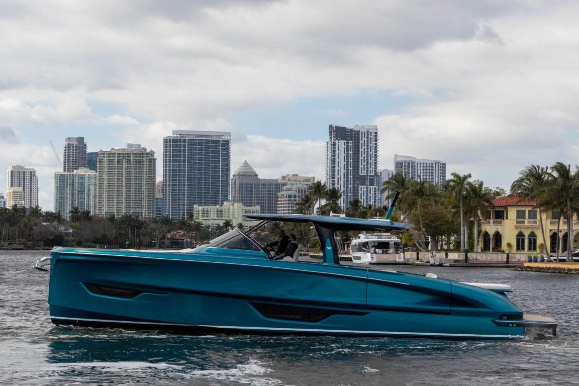2024 Solaris Power 52 Open yacht cruising near city skyline.
