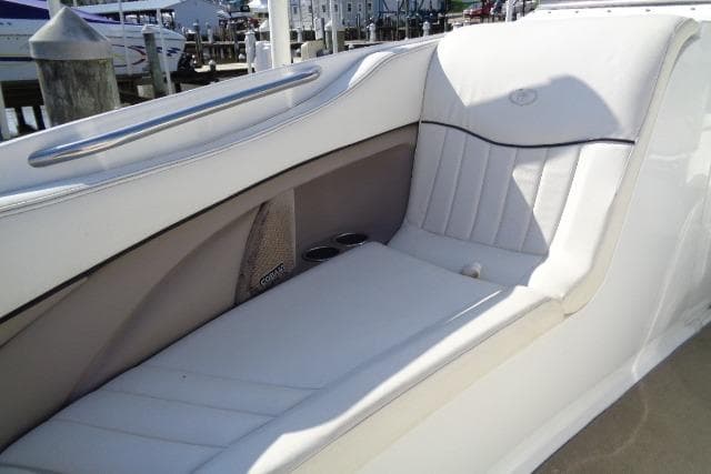 2006 Cobalt 282 boat interior with white leather seating and cup holders.