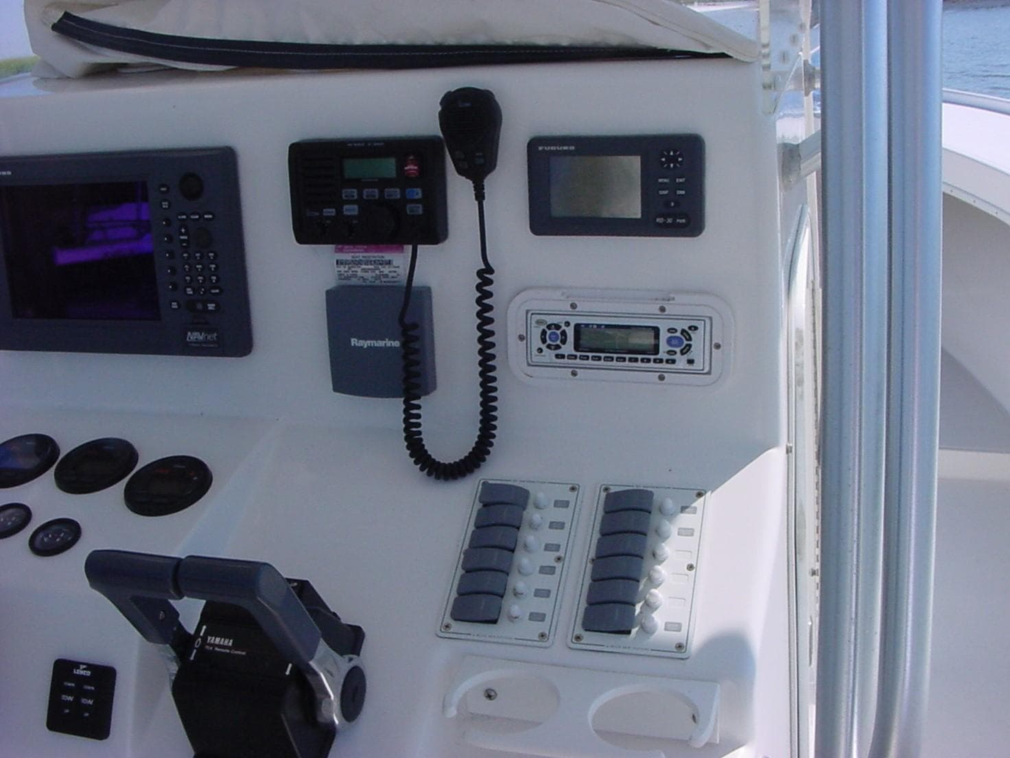 Control panel of a 2024 Jersey Cape 31 Little Devil boat with navigation and communication equipment.