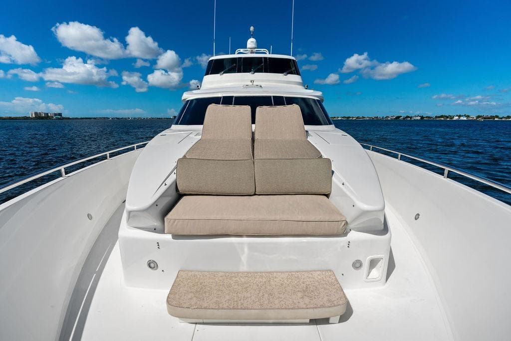 Luxurious Horizon 82 yacht deck with cushioned seating, cruising on a sunny day, 2005 model.