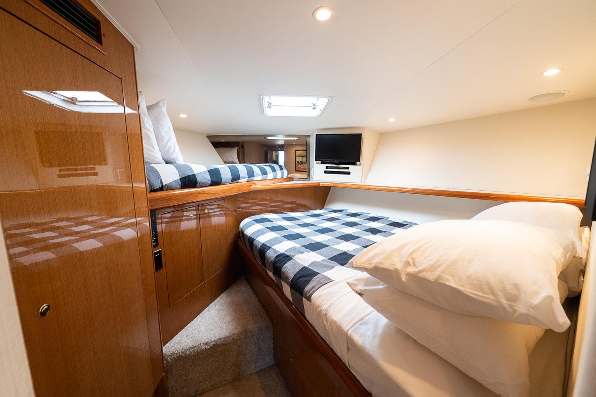 Luxurious cabin interior of 2003 Viking 48 Convertible yacht with cozy bedding and modern amenities.