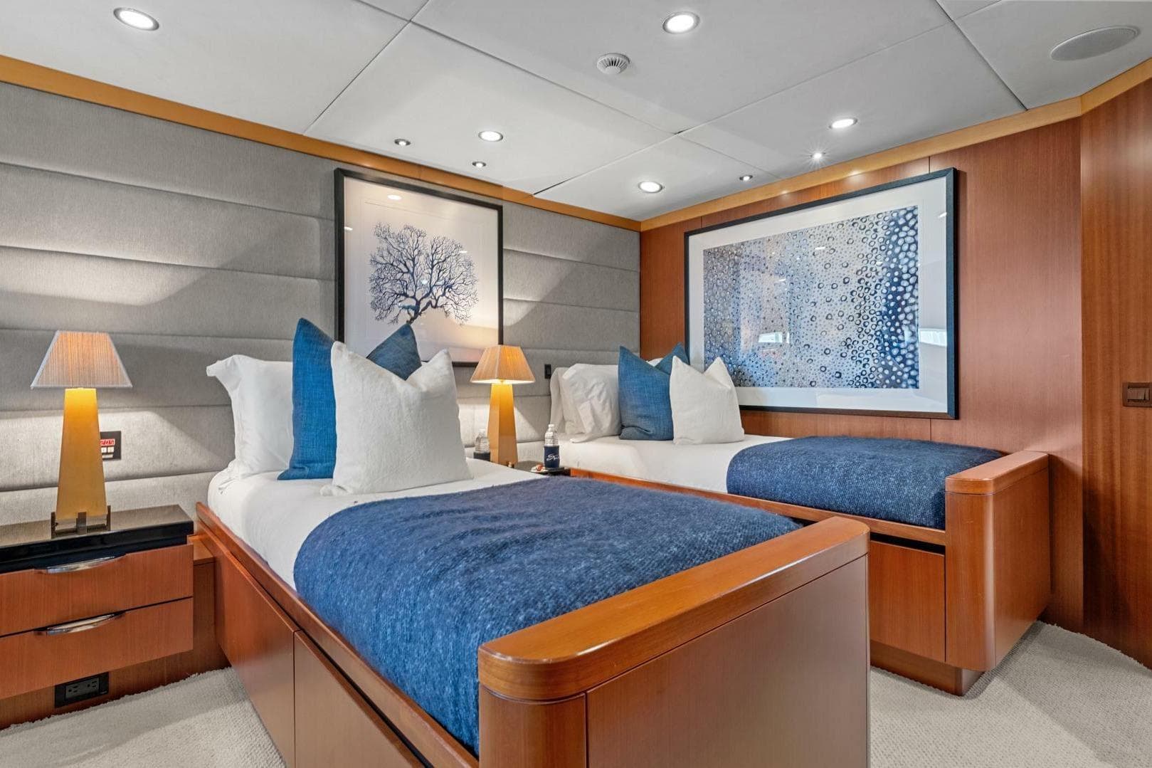 Luxurious twin bedroom on 2005 New Zealand Yachts 115 Wave Piercer, featuring elegant decor.