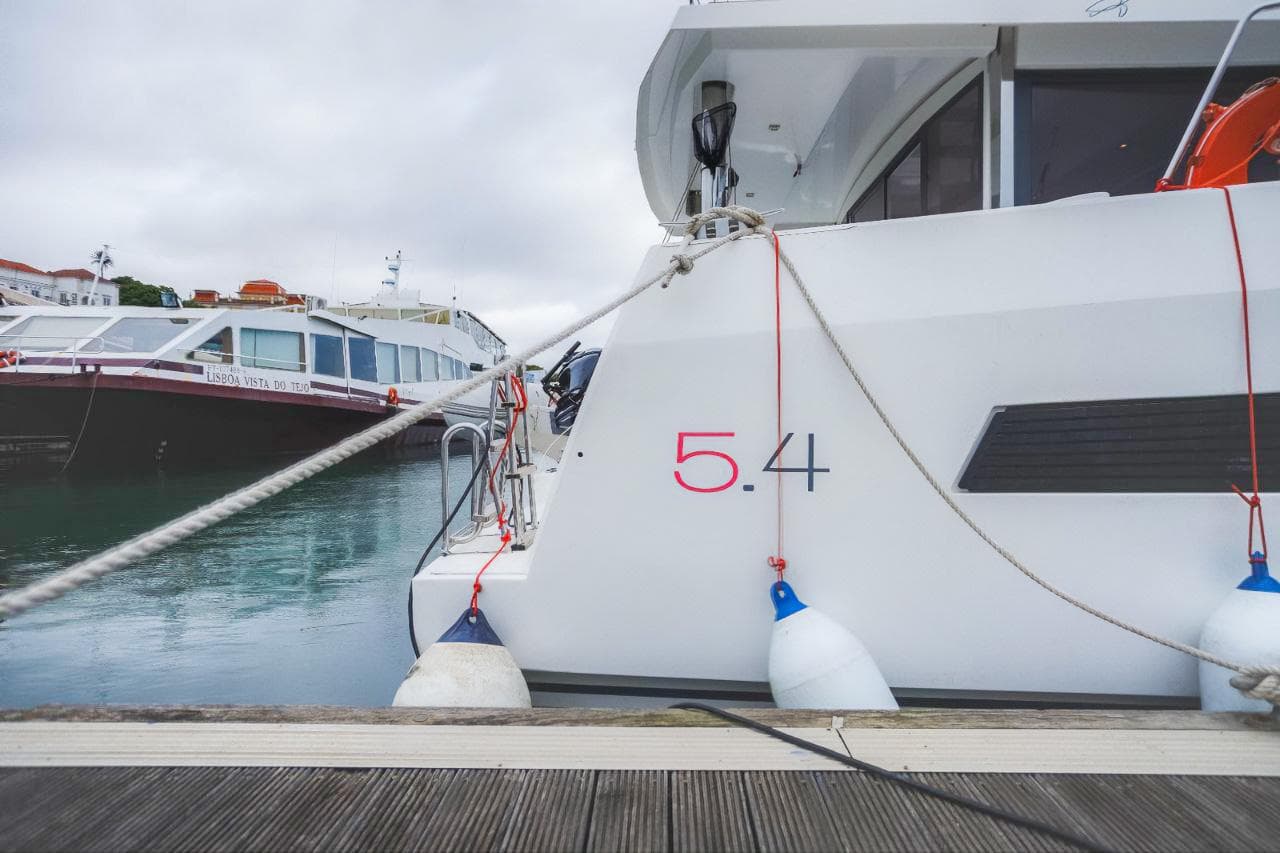 Bali 5.4 yacht docked at marina, 2019 model, with fenders and ropes.