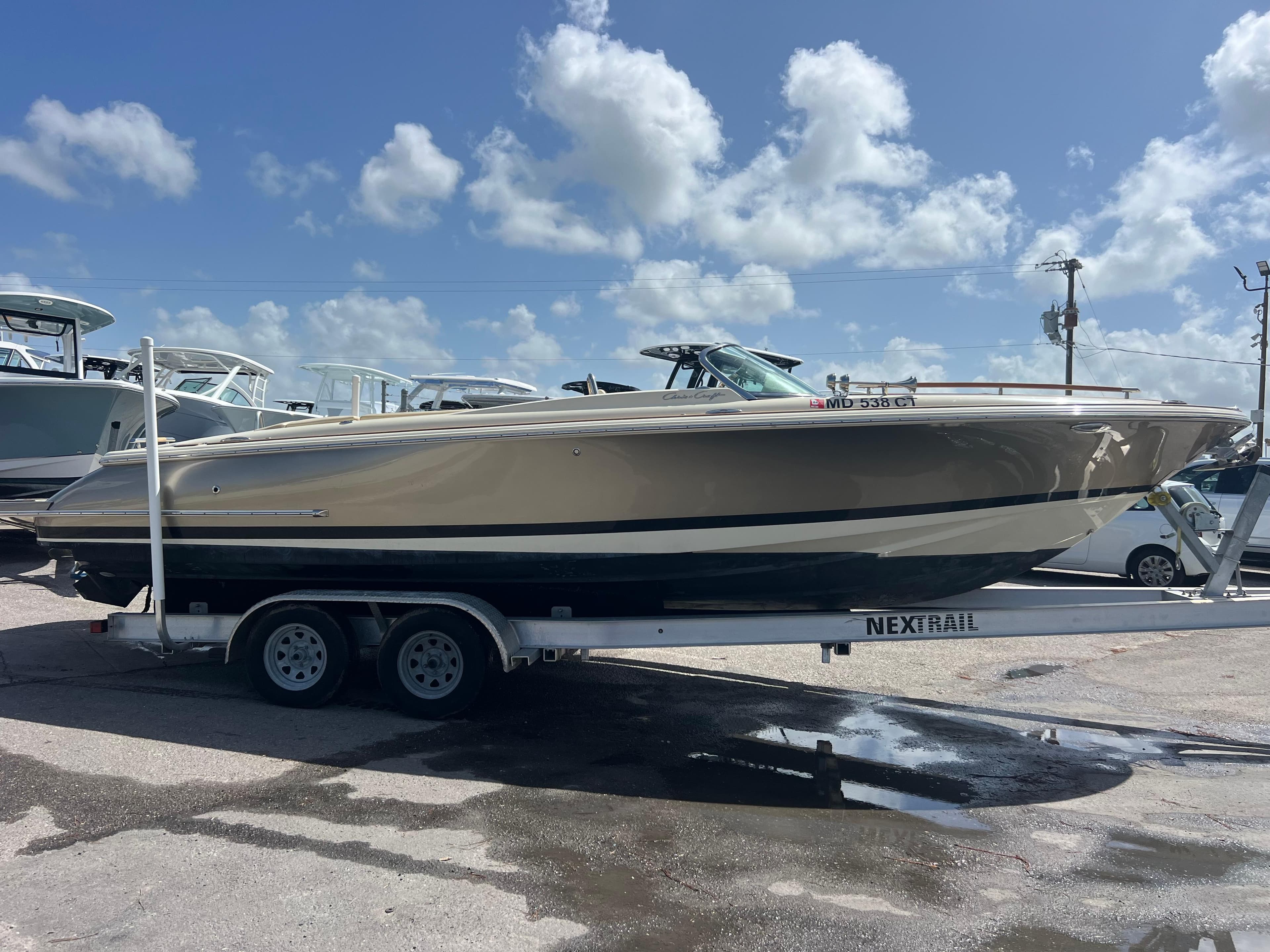 2019 Chris-Craft Corsair 27 boat on trailer under a clear blue sky.
