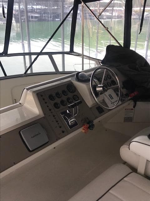 1996 Carver 370 boat helm with steering wheel and control panel.
