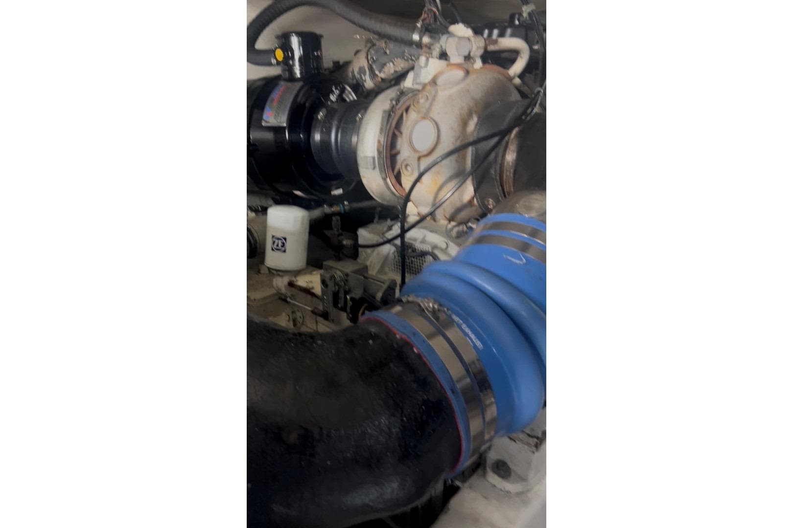 Engine compartment of a 1998 Ocean 53 Convertible yacht, featuring hoses and components.