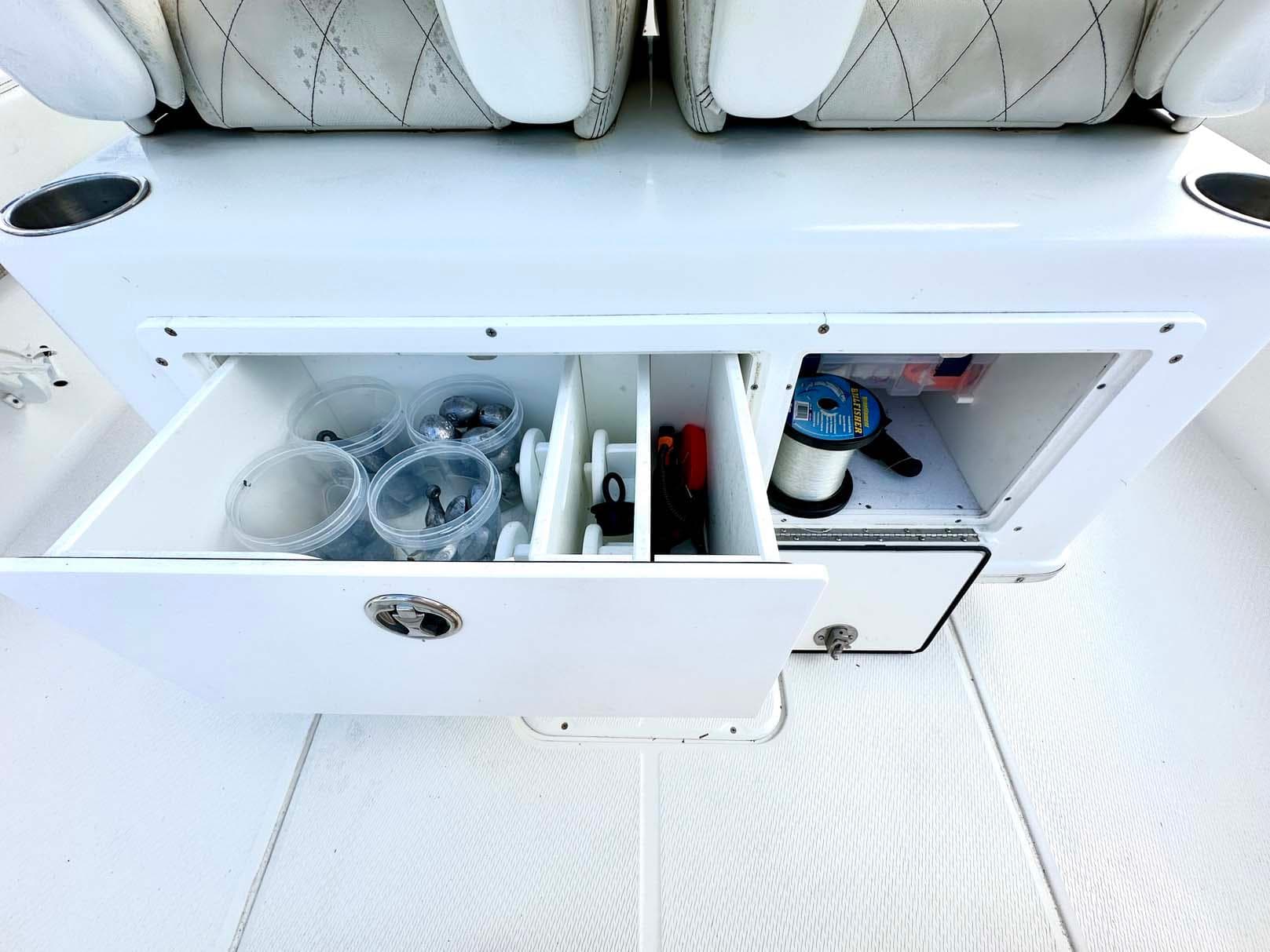 2020 Blue Wave 2800 Pure Hybrid boat storage compartment with fishing gear and accessories.