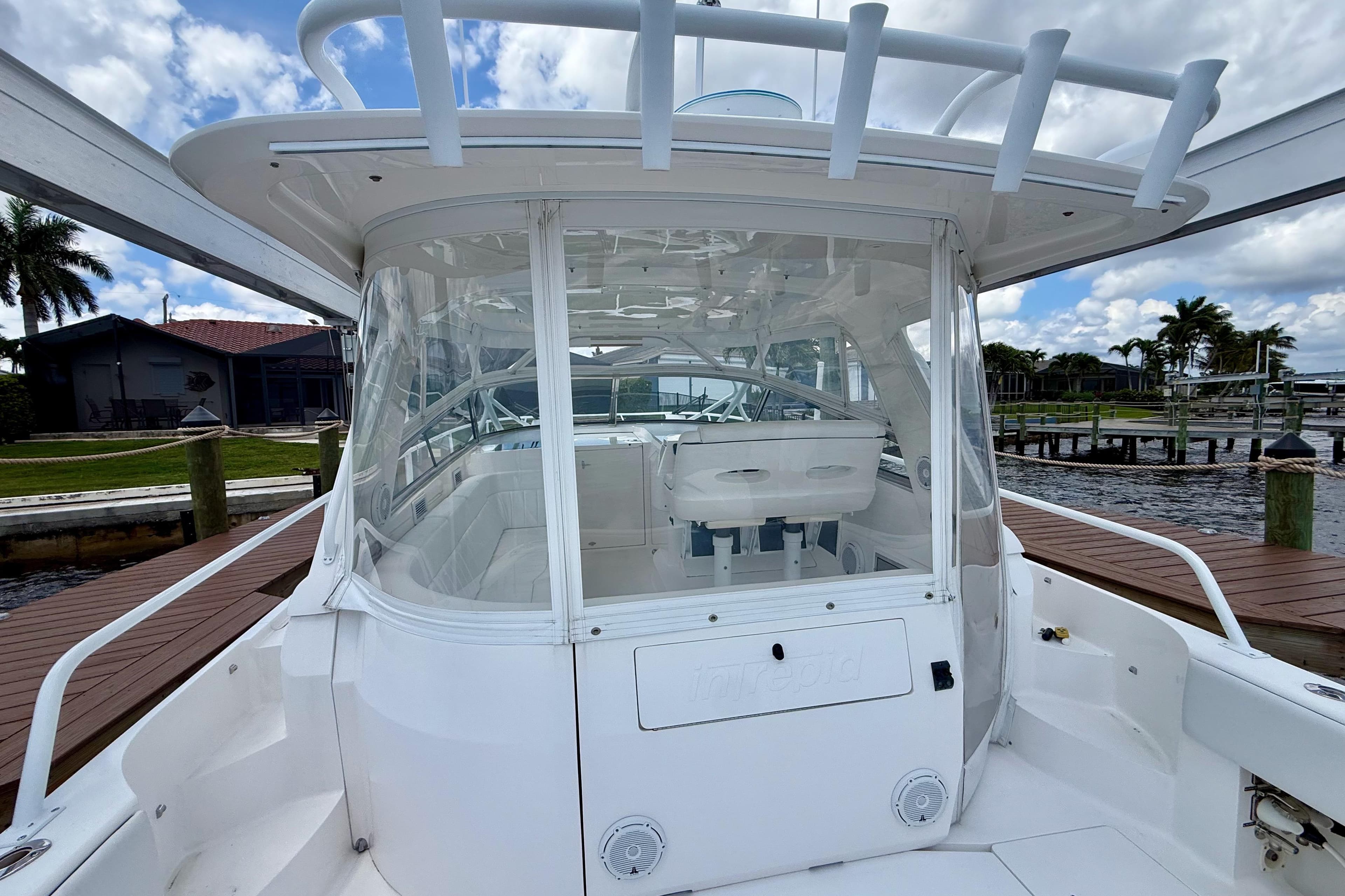 2013 Intrepid 430 Sport Yacht docked, showcasing sleek design and spacious cockpit.