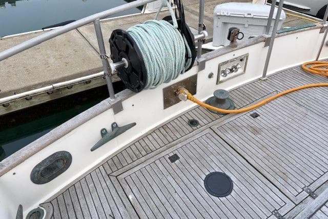 1984 Grand Banks Classic boat deck with coiled rope and dockside connection.