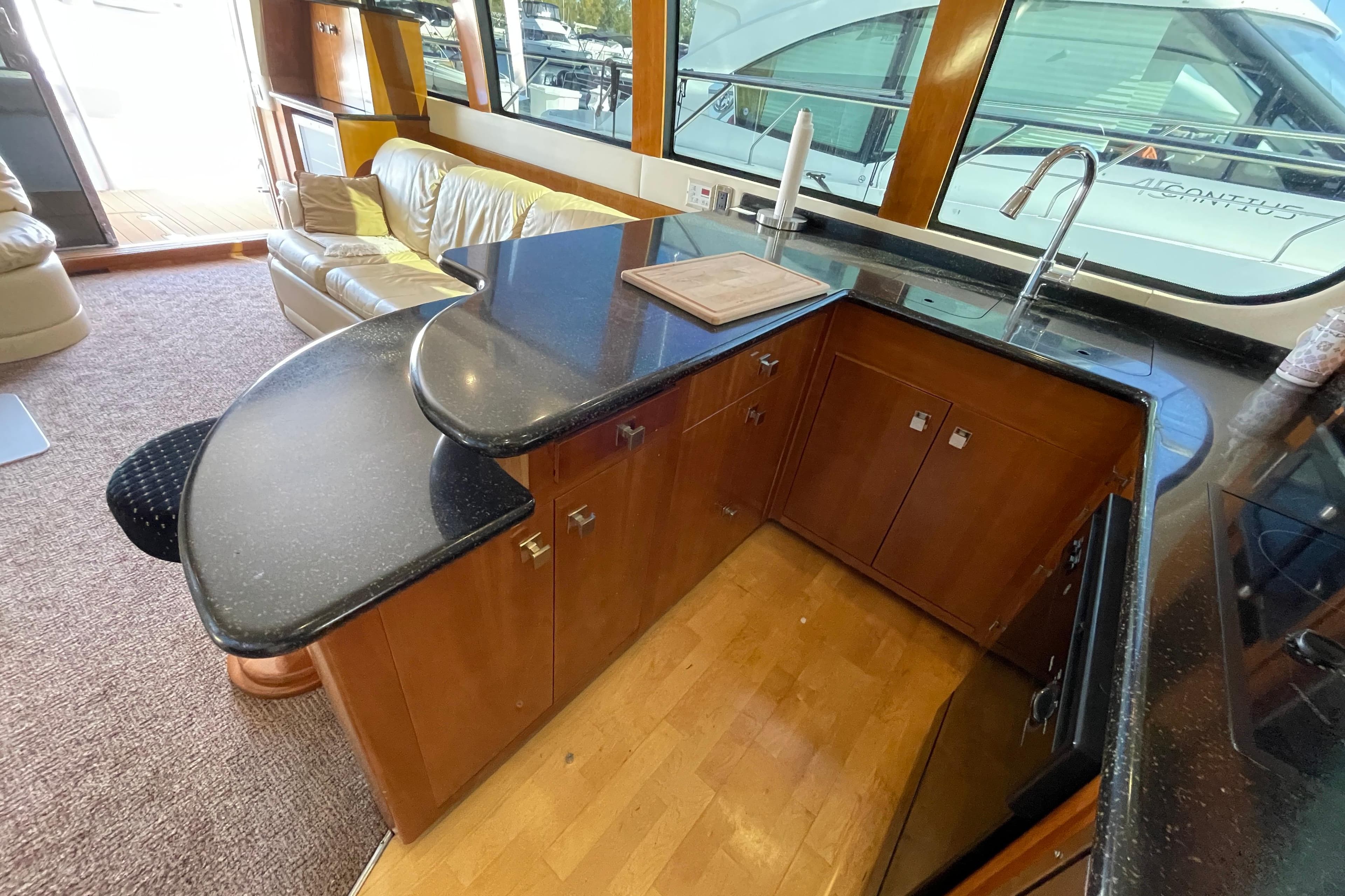 Luxurious kitchen area in a 2002 Carver 570 Voyager Pilothouse yacht with sleek countertops.