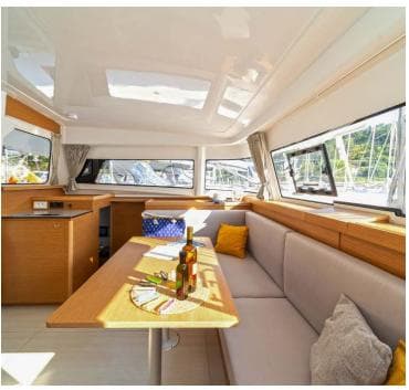 Luxurious interior of 2023 Excess 11 yacht with cozy seating and dining area.