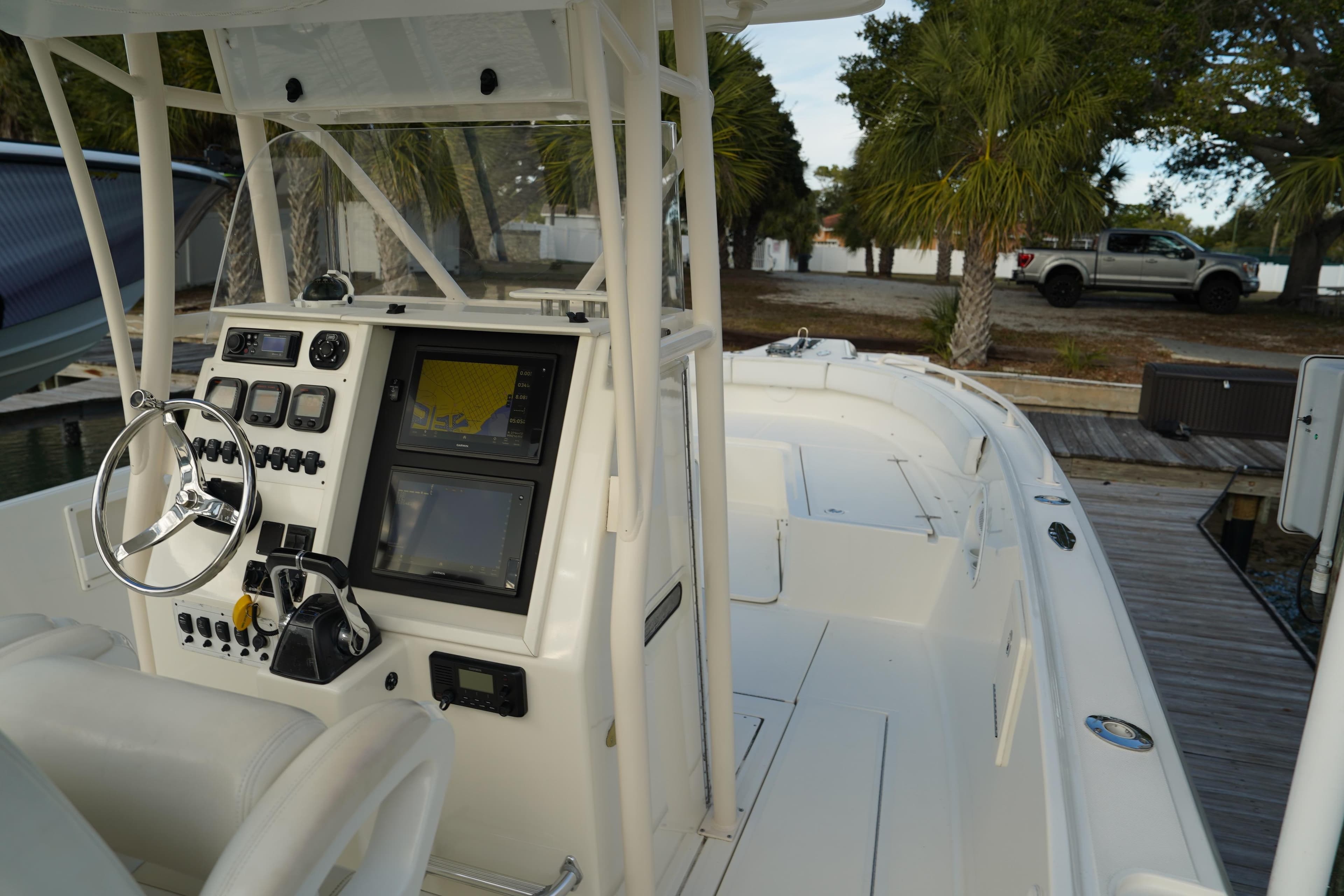 2013 Stamas 317 Tarpon boat cockpit with steering wheel and navigation controls.