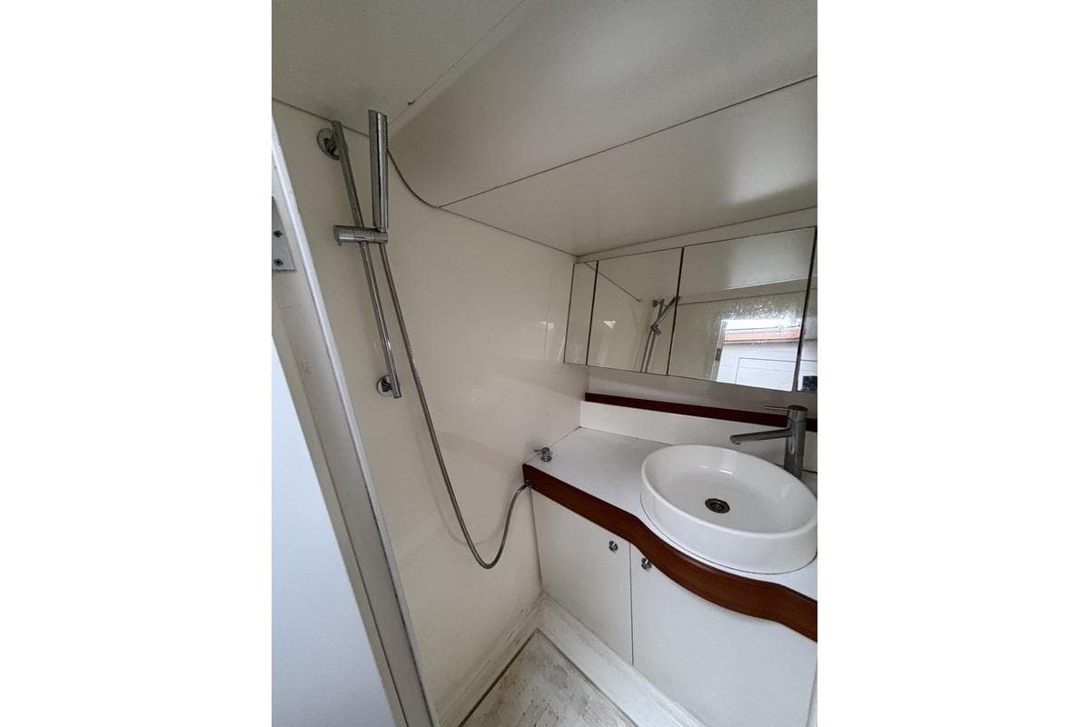 Bathroom interior of 2016 Nautor Swan ClubSwan 50 yacht, featuring modern sink and shower.