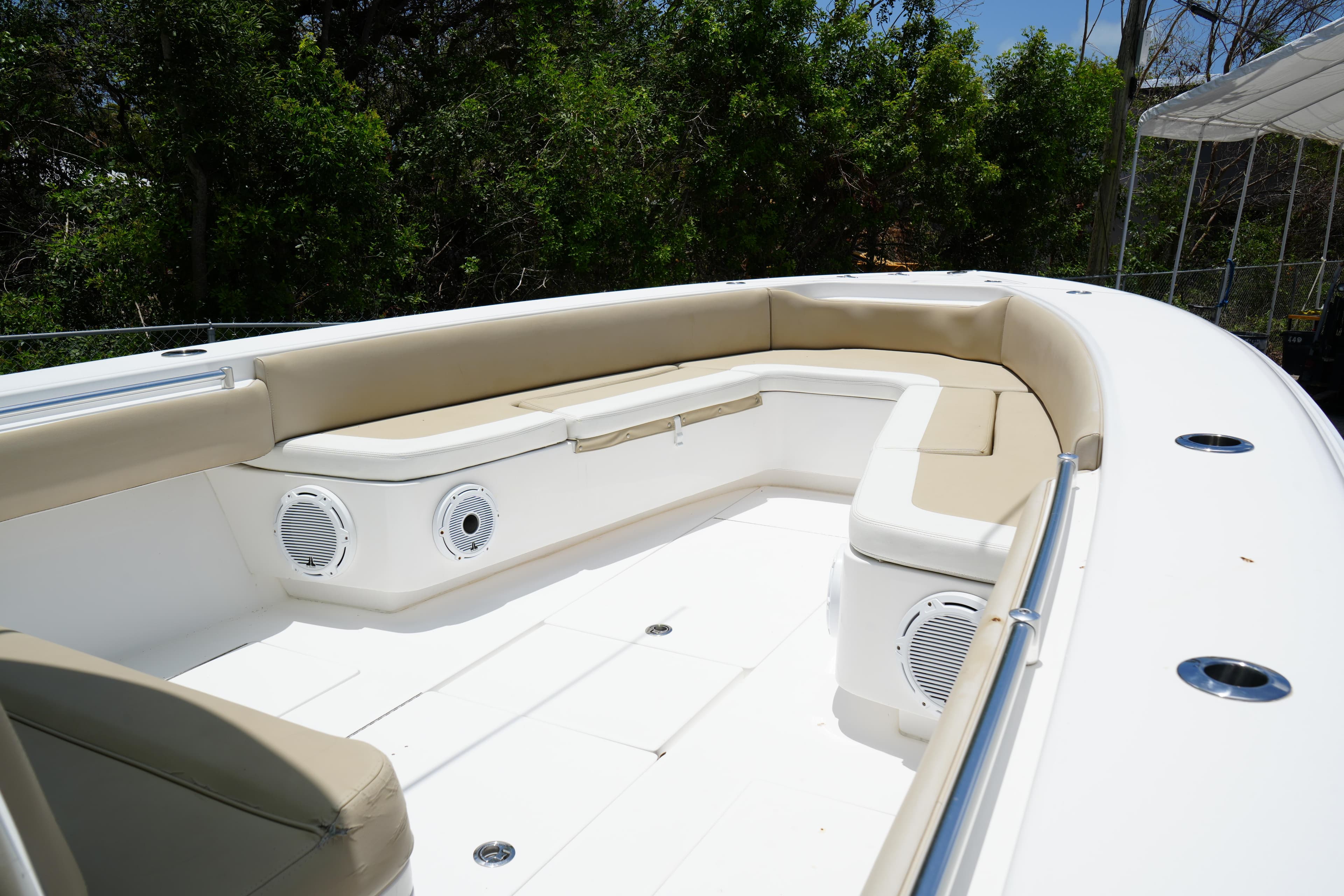 2015 Contender 39ST boat interior with beige seating and built-in speakers.
