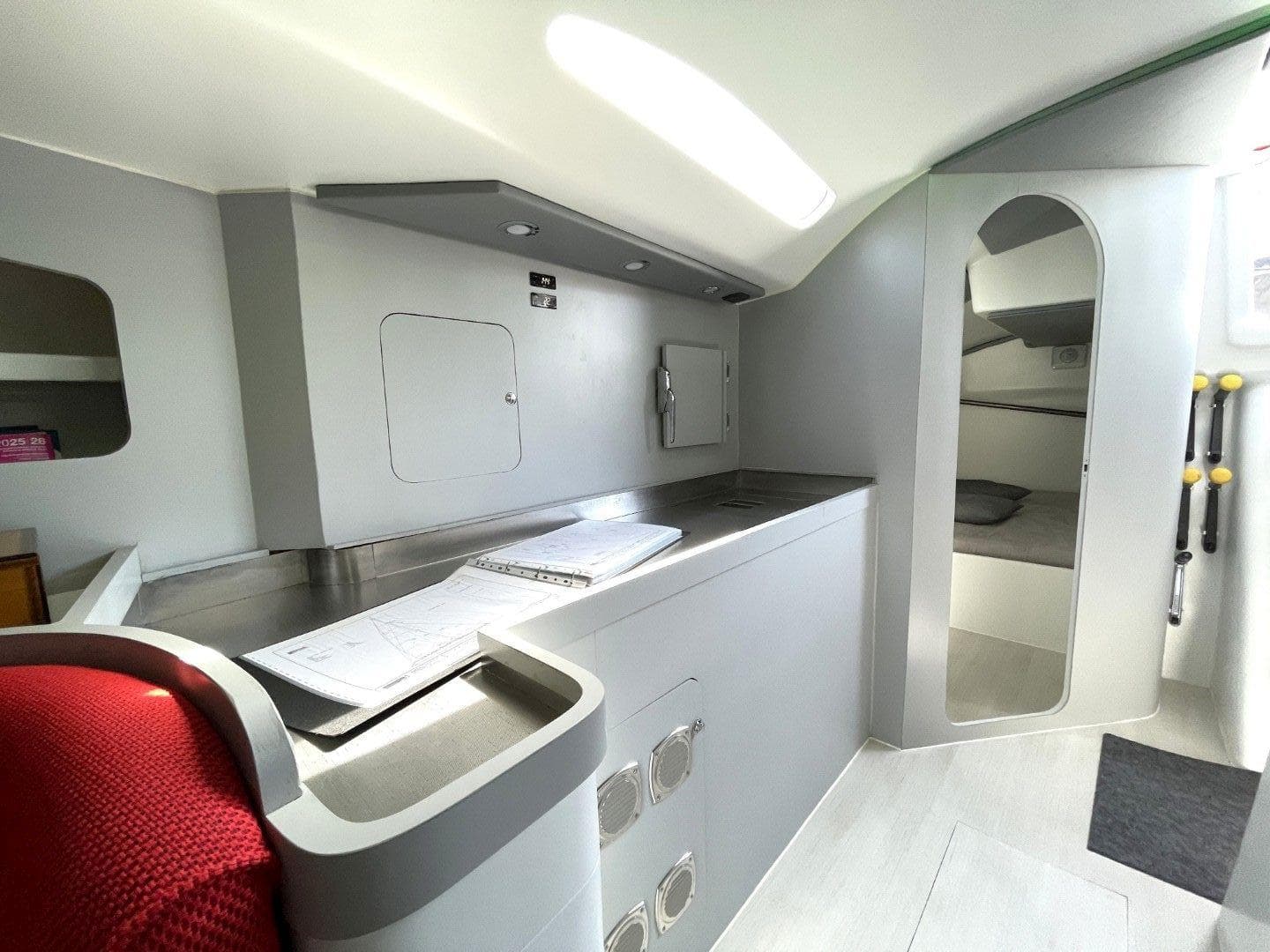 Interior of a 2002 Bakewell-White 20m Pocket Maxi yacht, featuring modern design and compact layout.