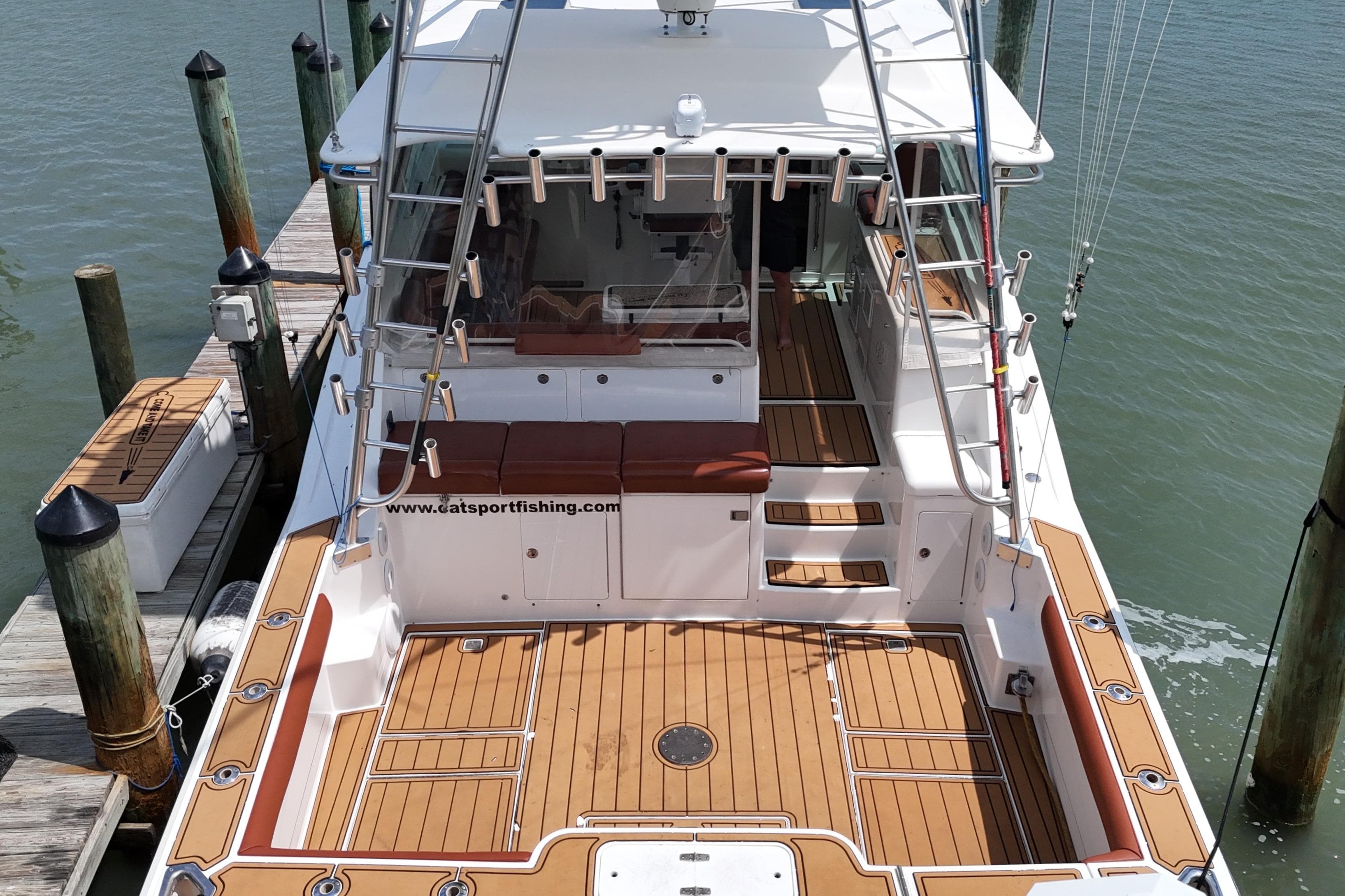 Cabo 45 Express 2000 model docked, featuring spacious deck and fishing equipment.