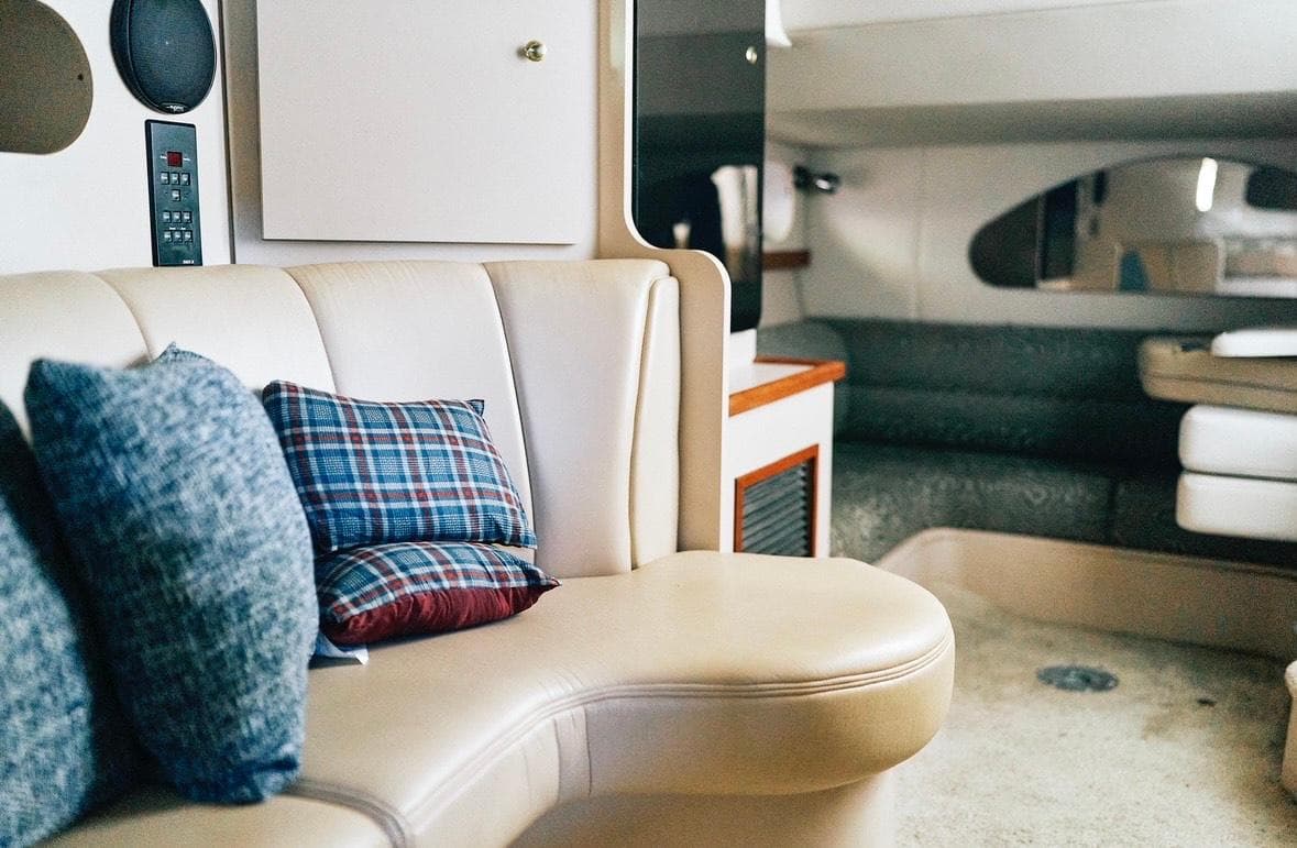 Interior of 2001 Cruisers Yachts 3075 Express with plush seating and decorative pillows.