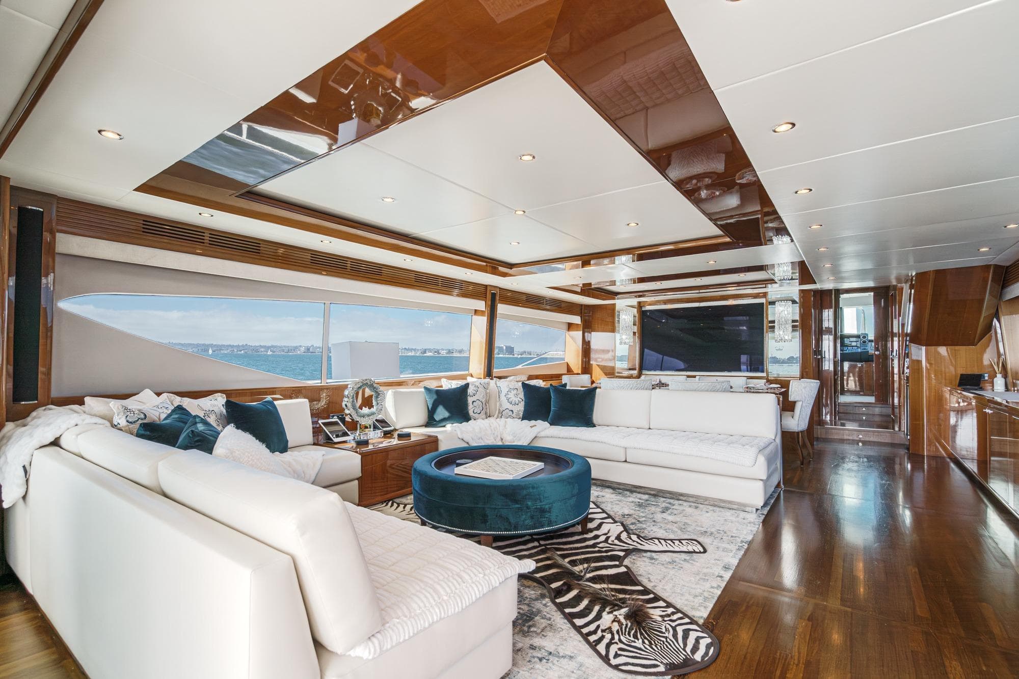 Luxurious interior of 2011 Princess 95 Motor Yacht with elegant furnishings and panoramic windows.
