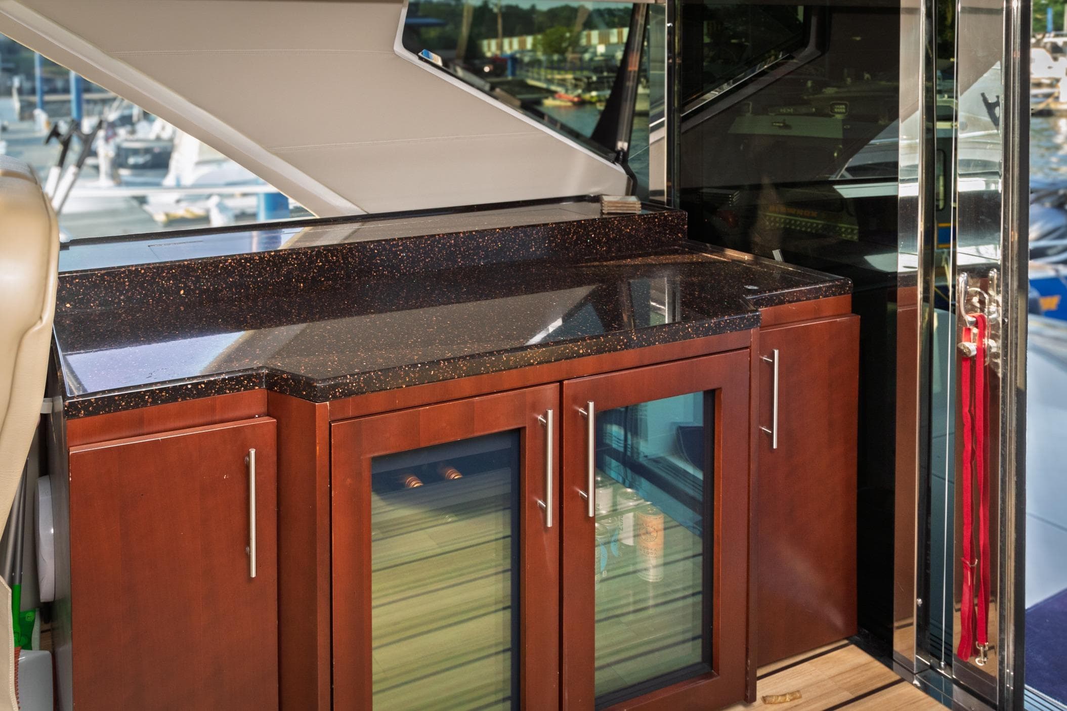 Luxurious interior of 2015 Regal 53 Sport Coupe with sleek countertop and wooden cabinetry.