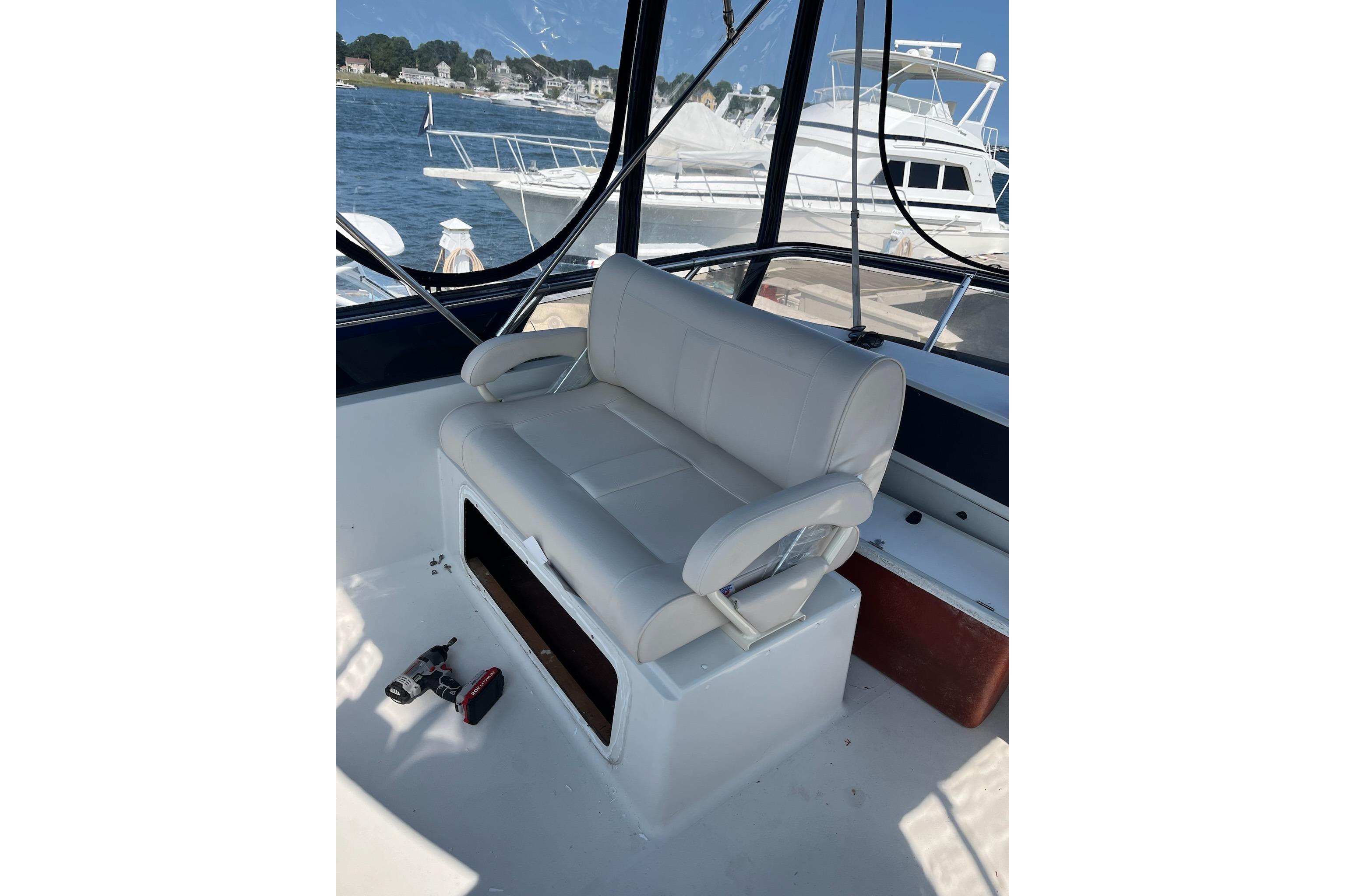 1993 Carver 30 Santego boat interior with white seating, docked by the water.