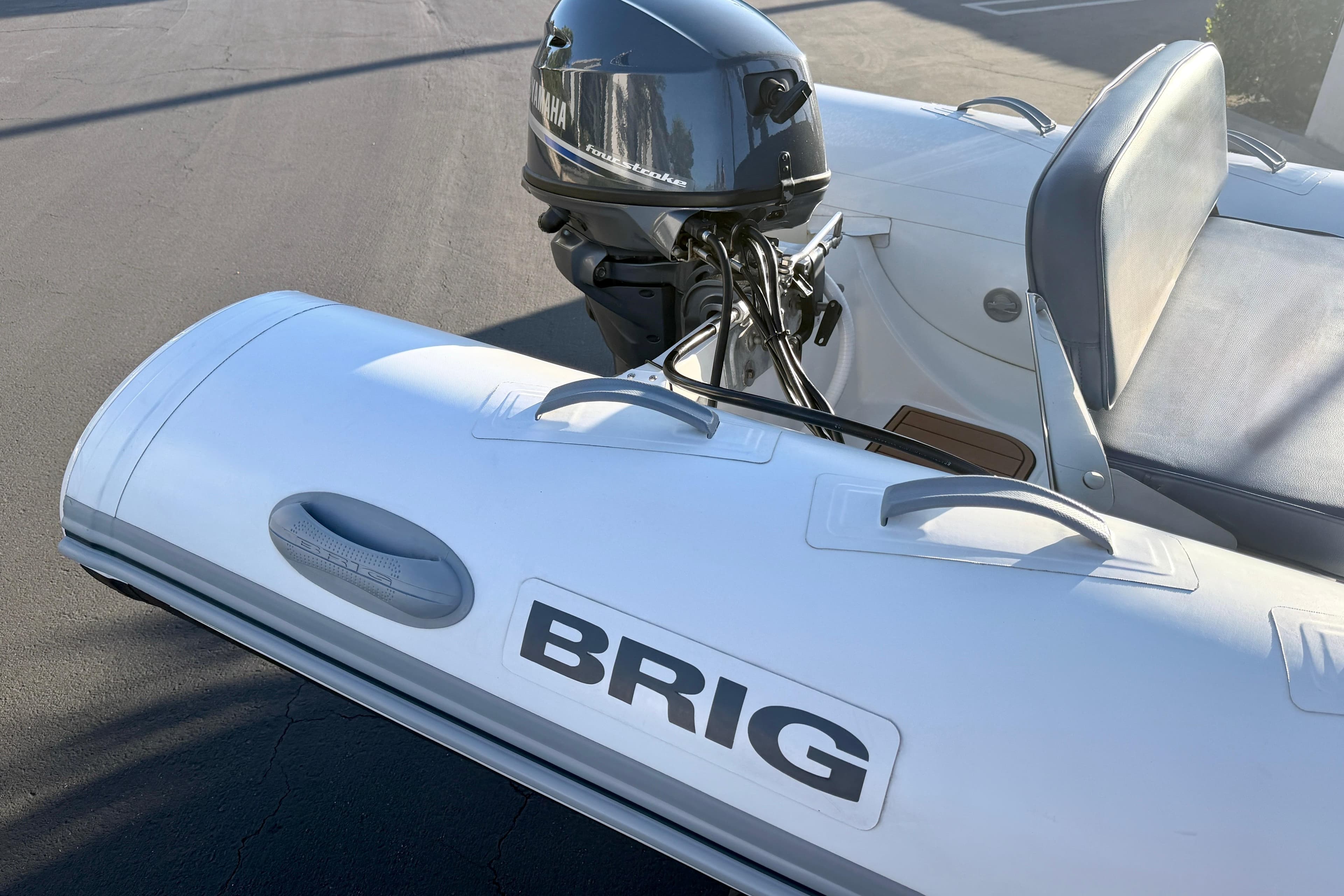 2018 Brig Falcon 360 inflatable boat with Yamaha outboard motor, parked on pavement.