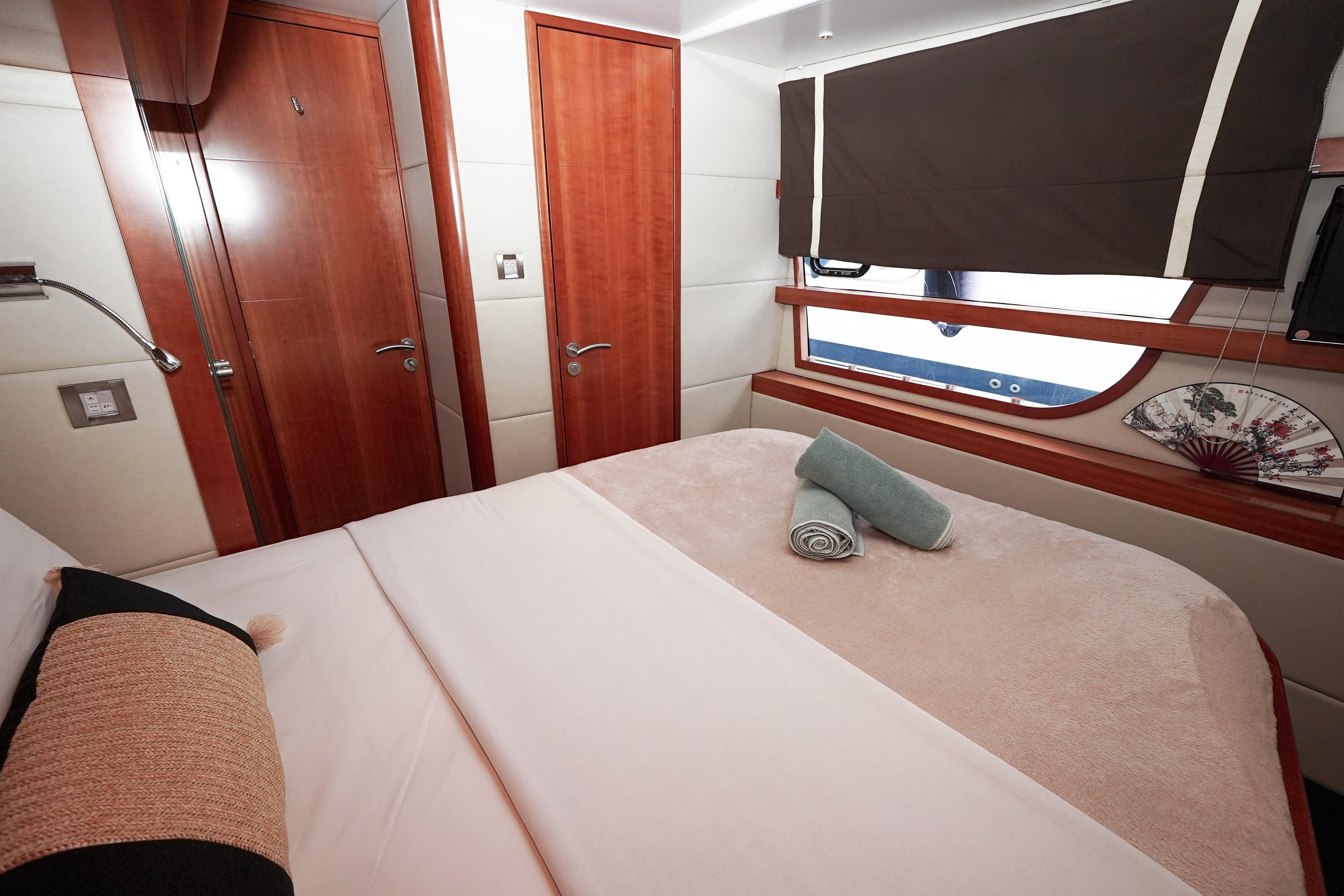Luxurious cabin interior of 2010 Fountaine Pajot Queensland 55 yacht with elegant wood finishes.