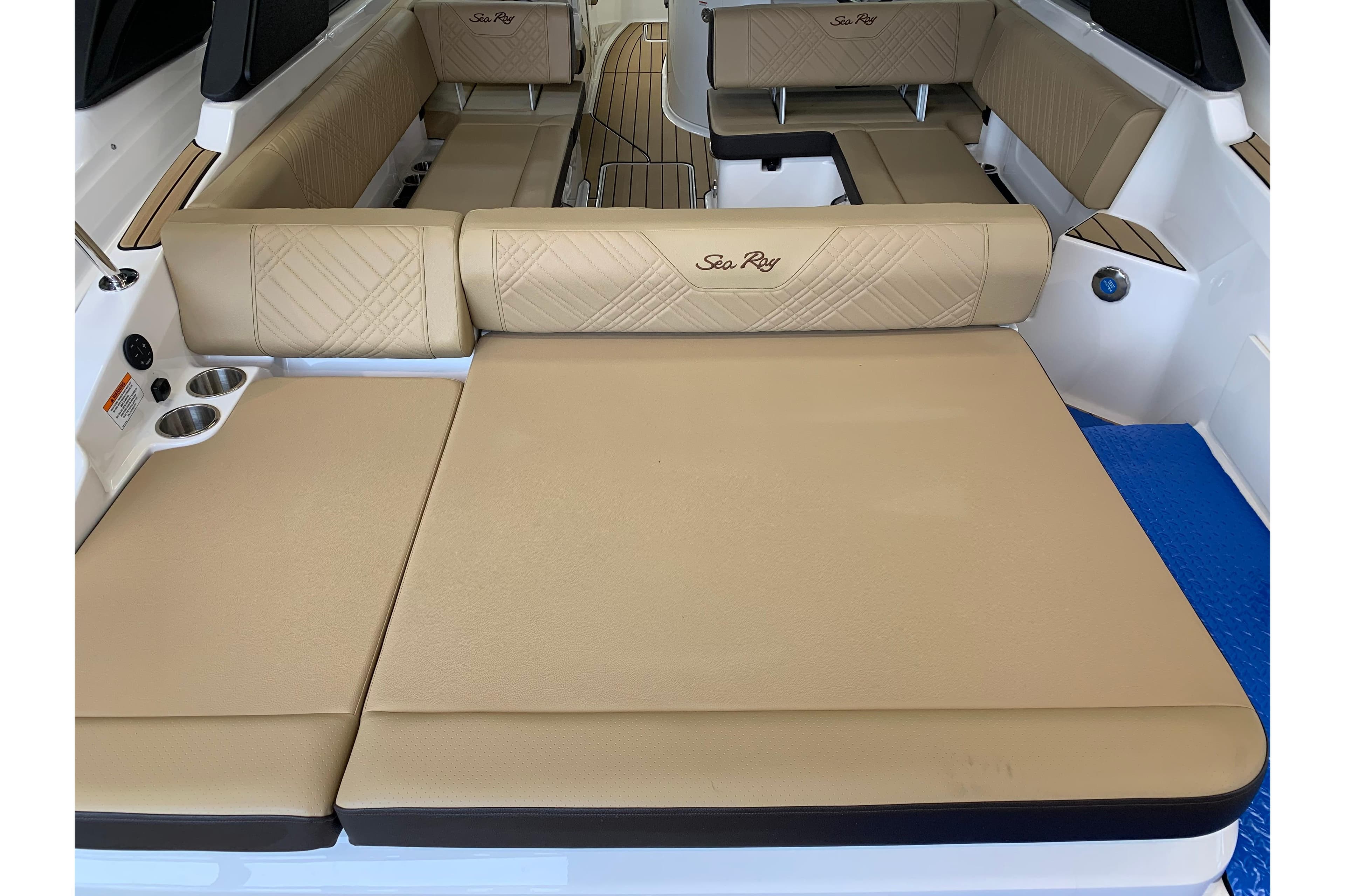 2025 Sea Ray SDX 270 boat interior with beige seating and cup holders.