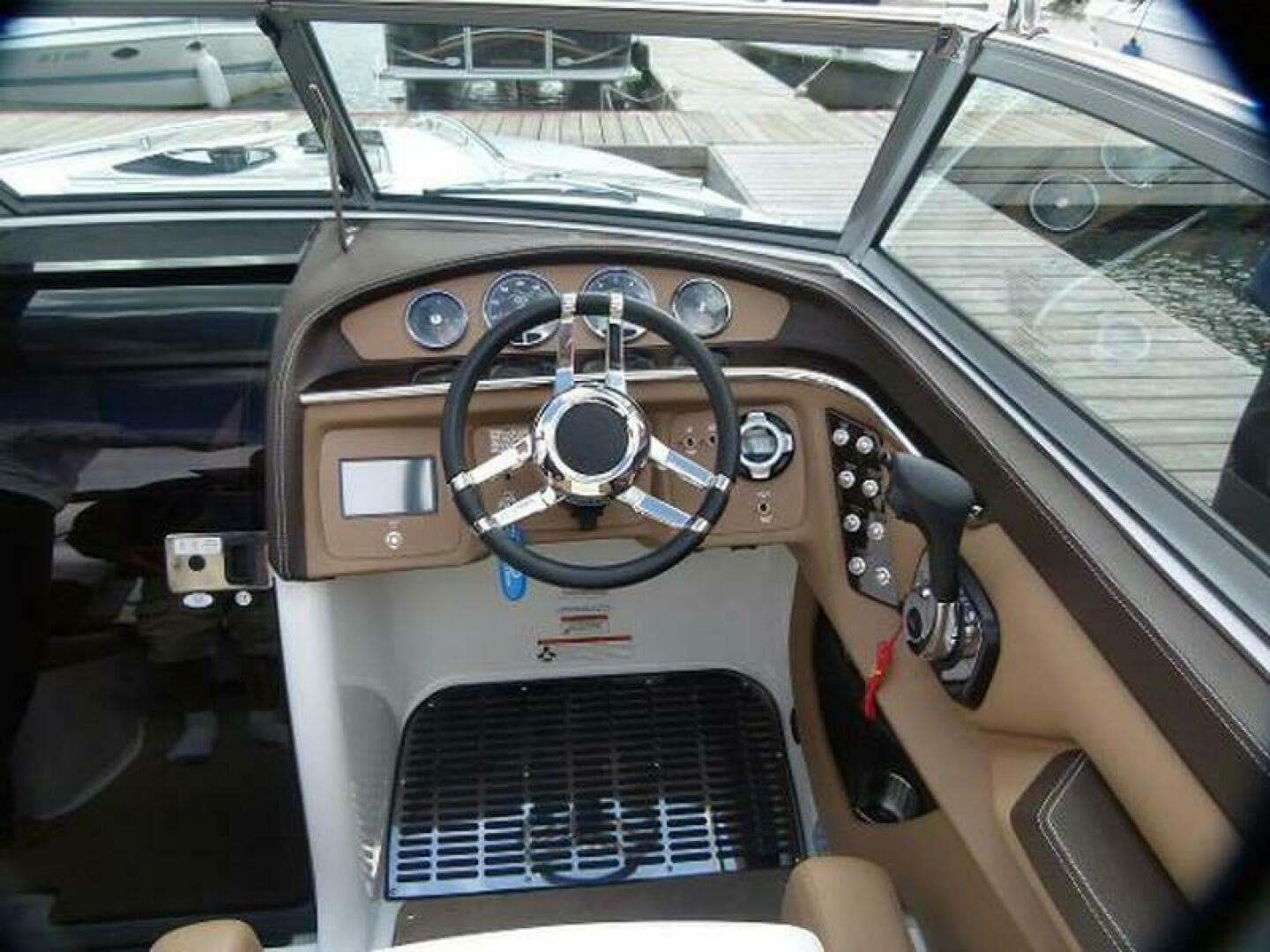 2012 Cobalt 273 boat dashboard with steering wheel and control panel.