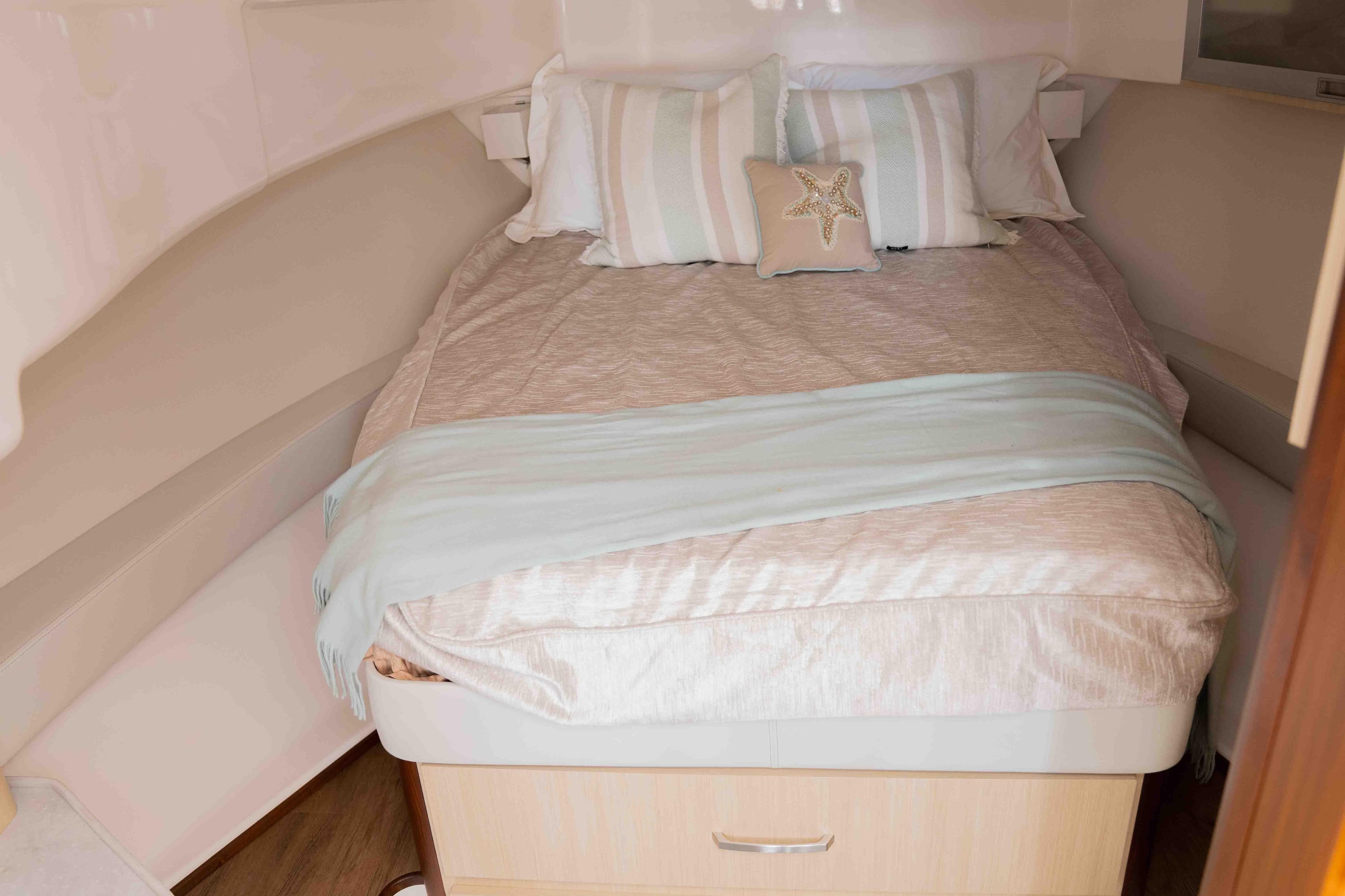 Luxurious cabin interior of 2024 Regal 36 Grande Coupe with cozy bedding.