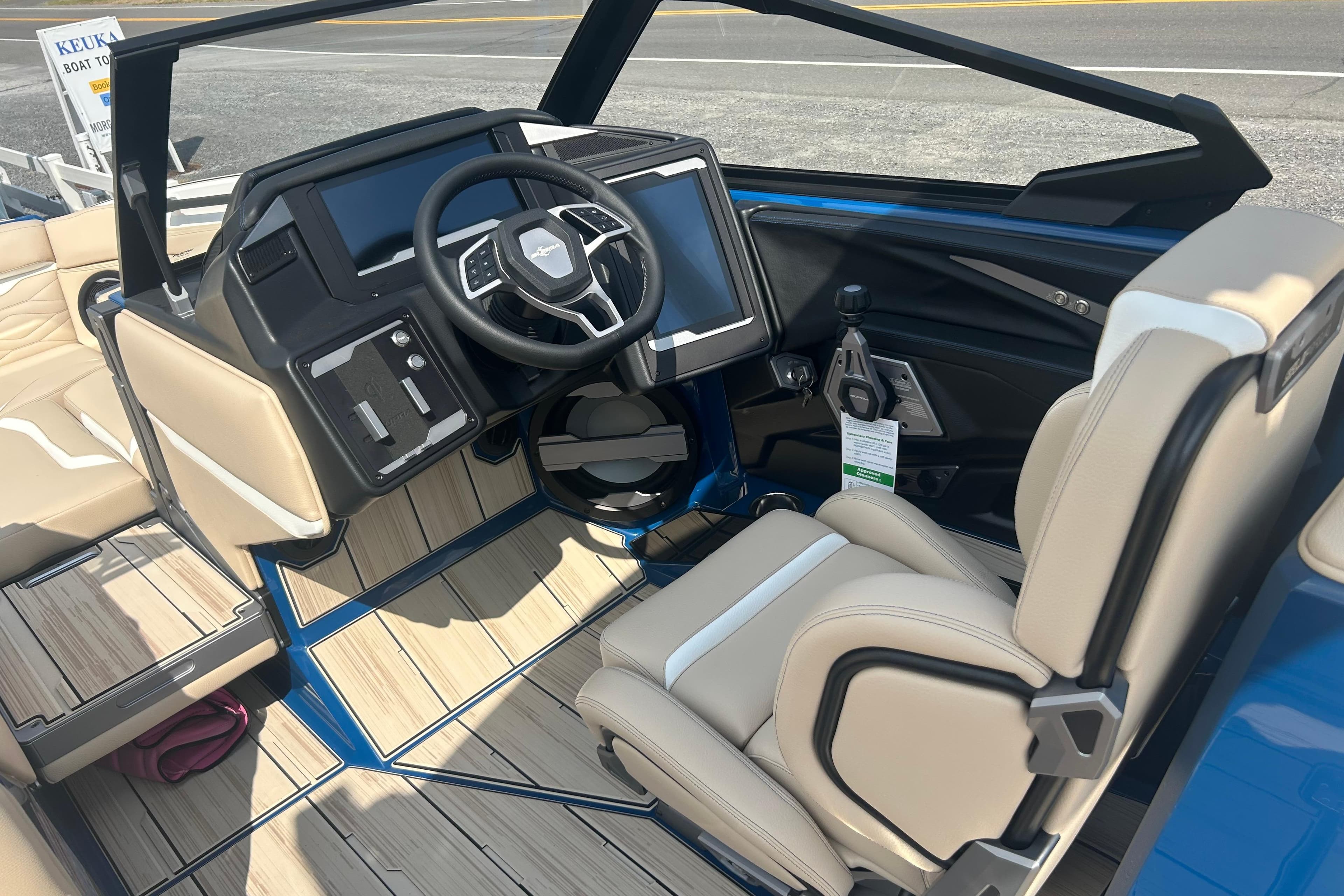 2025 Supra SV boat interior with modern dashboard and beige seating.
