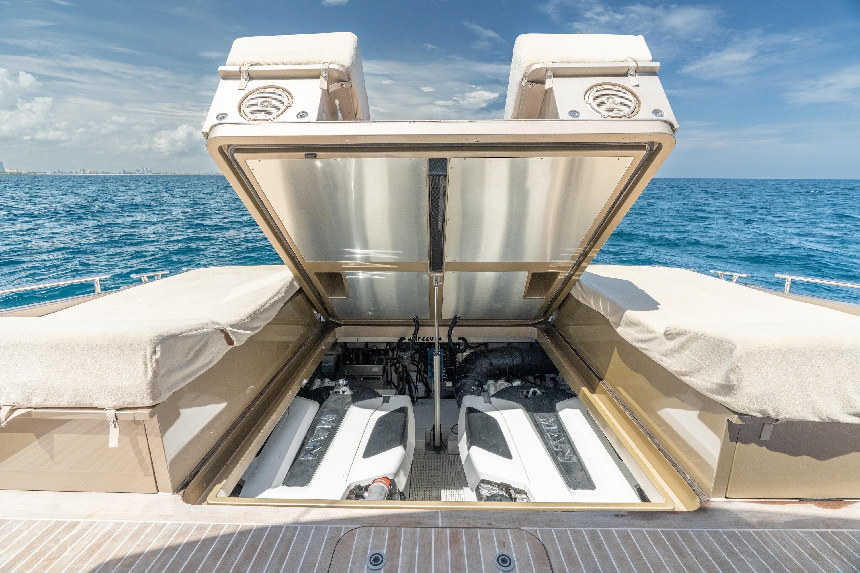 2019 CNM Continental 54 yacht engine compartment open, revealing dual engines at sea.