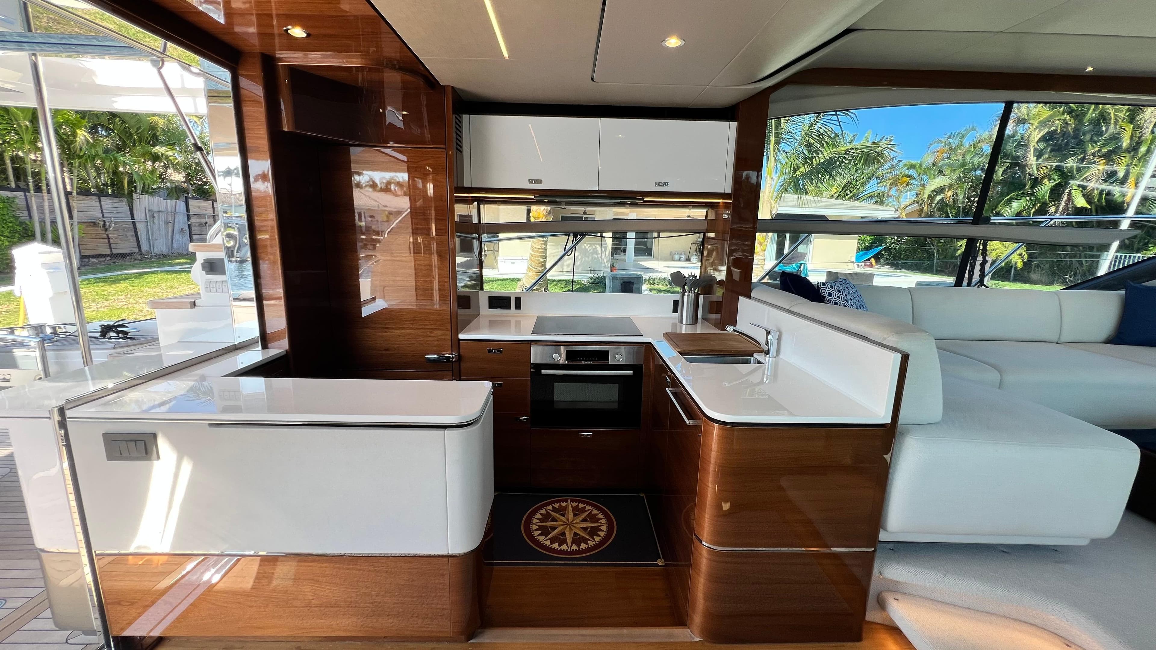 Luxurious 2019 Princess F62 yacht interior with modern kitchen and elegant wood finishes.