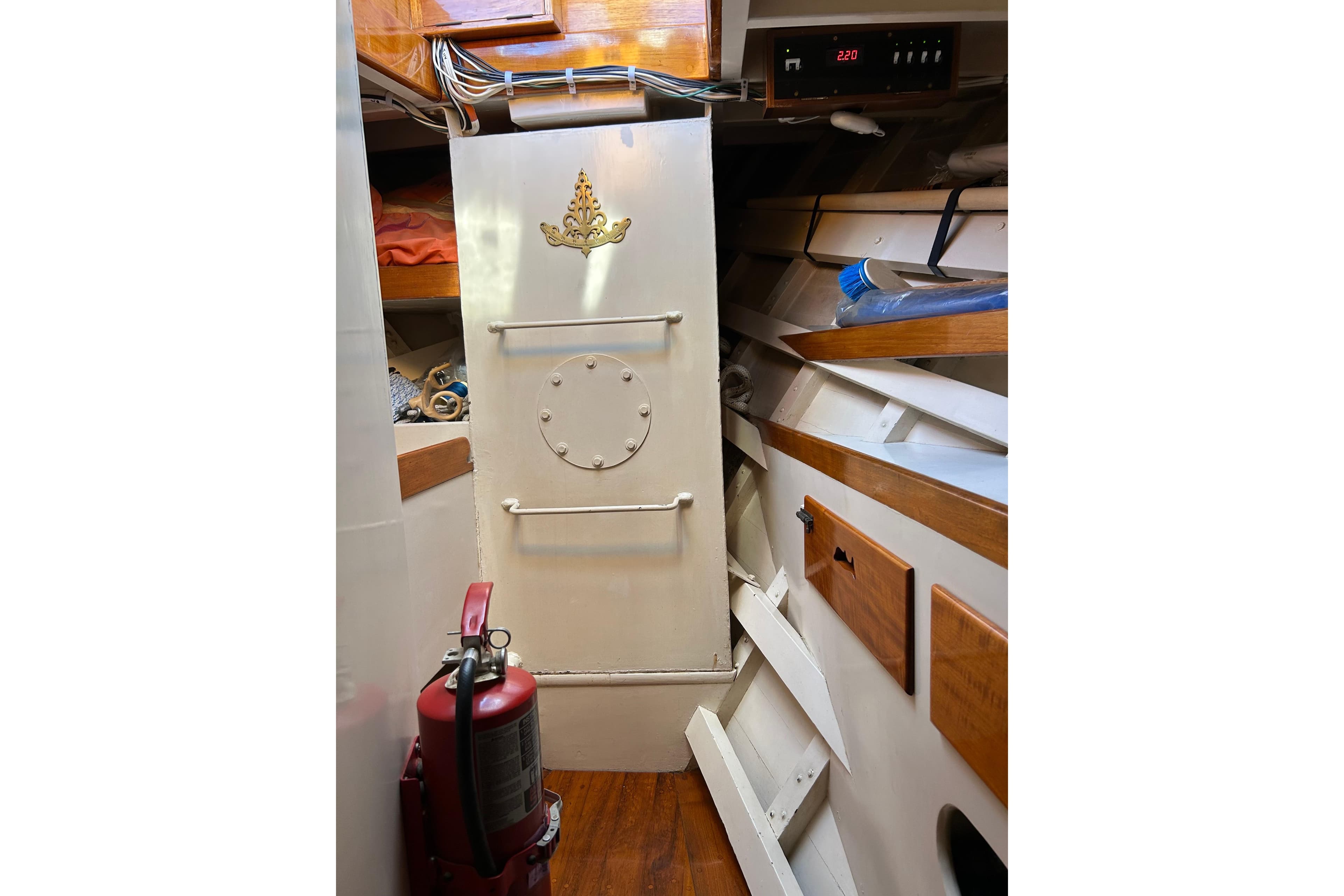 Interior of 1975 Robin Fong PORPOISE boat with fire extinguisher and storage compartments.