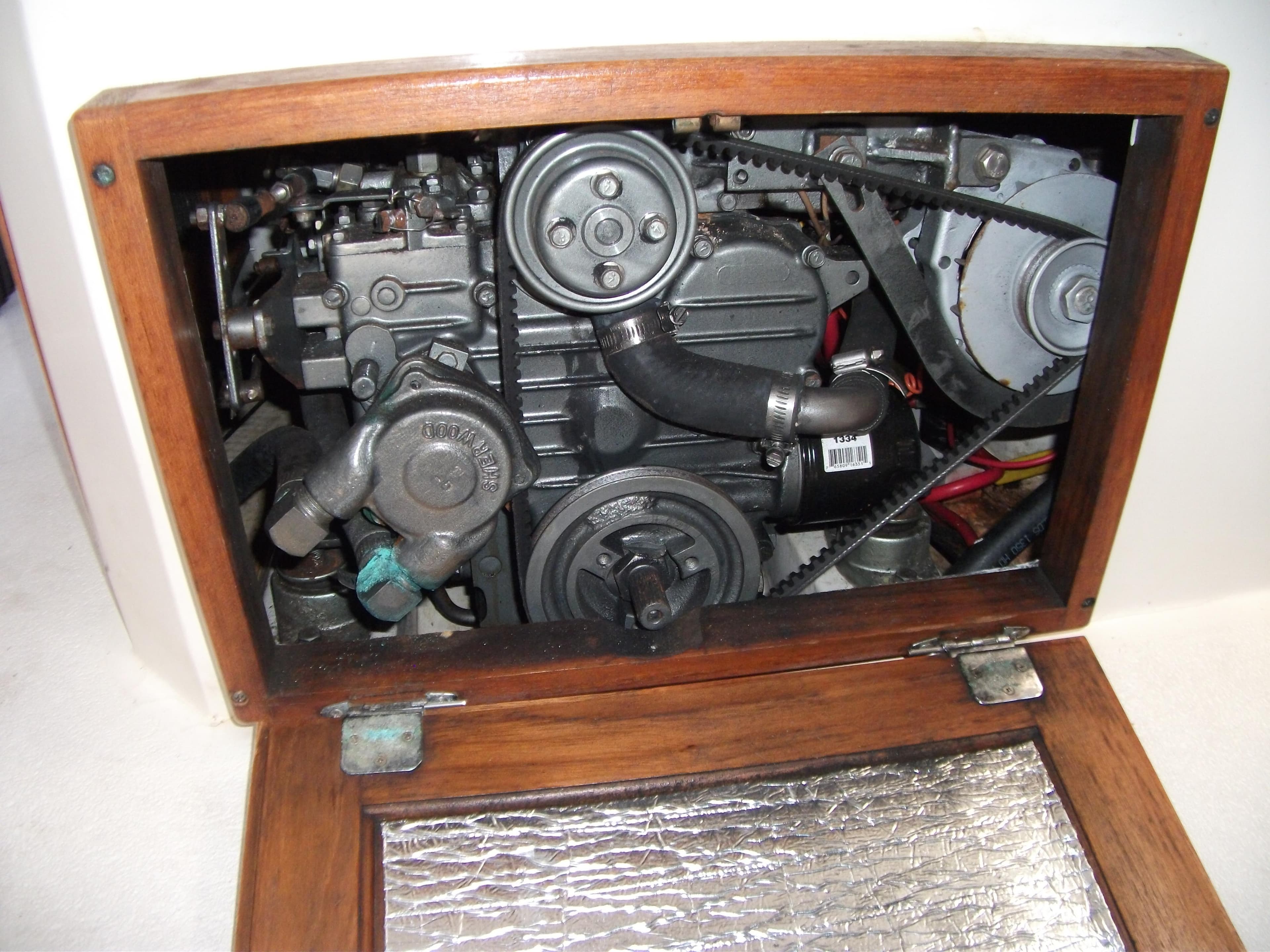 Engine compartment of a 1992 Catalina 30 MkII sailboat, showcasing mechanical components.