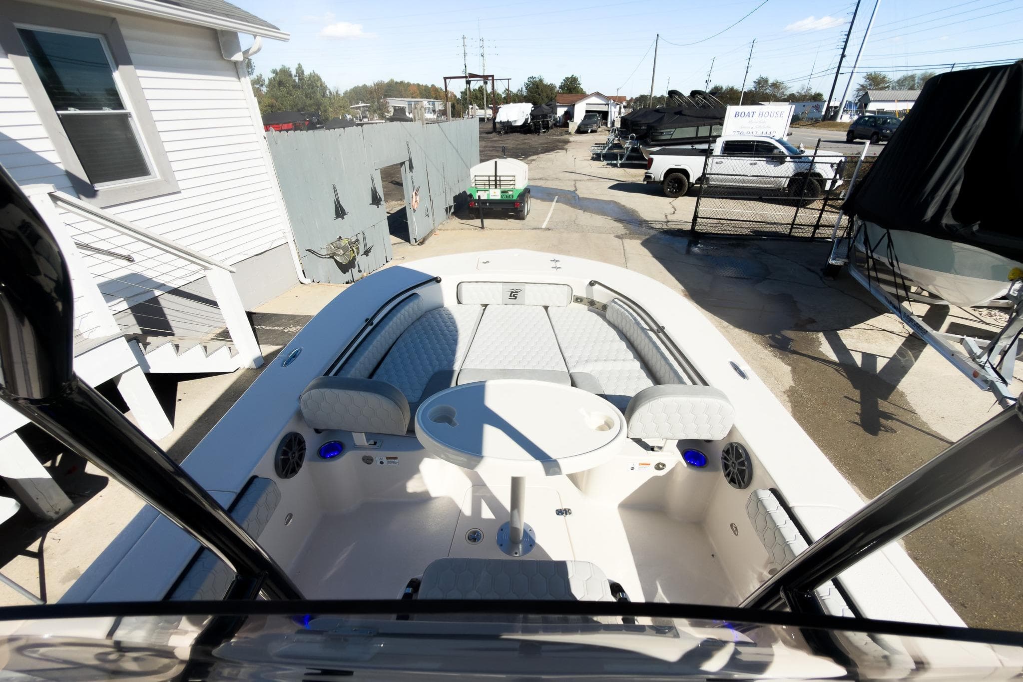 2026 Carolina Skiff 22 Ultra Elite boat interior with seating and table, parked at a marina.