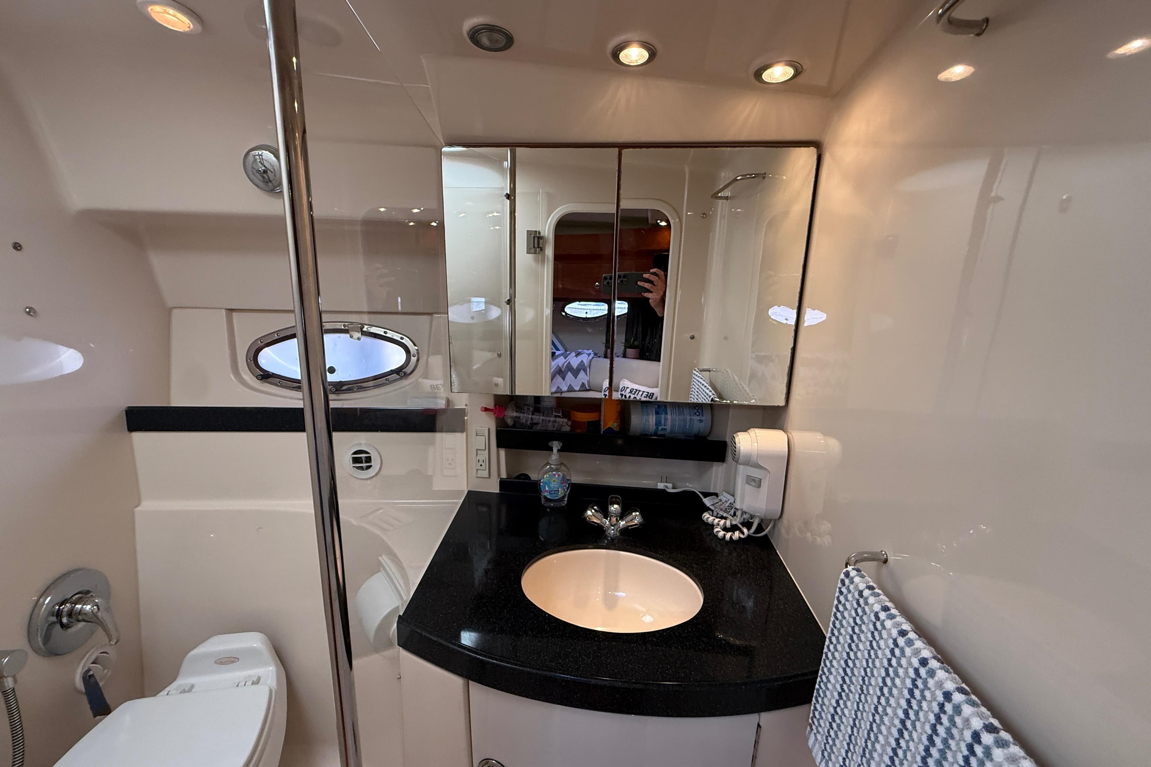 Luxurious bathroom in 2005 Regal Commodore 3560 IO yacht with modern fixtures and elegant design.