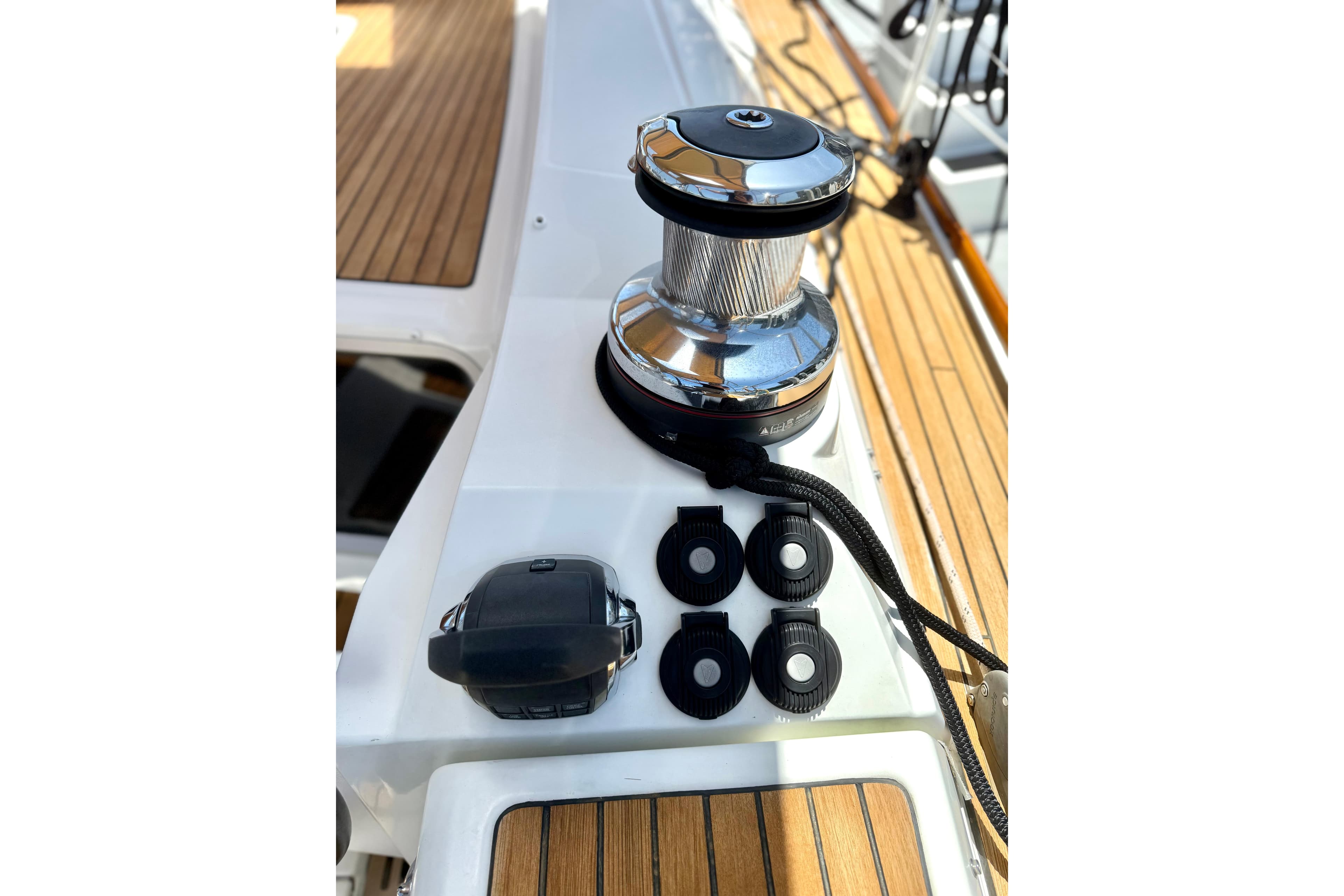 Deck equipment on a 2018 Jeanneau 58 yacht, featuring winch and control buttons.