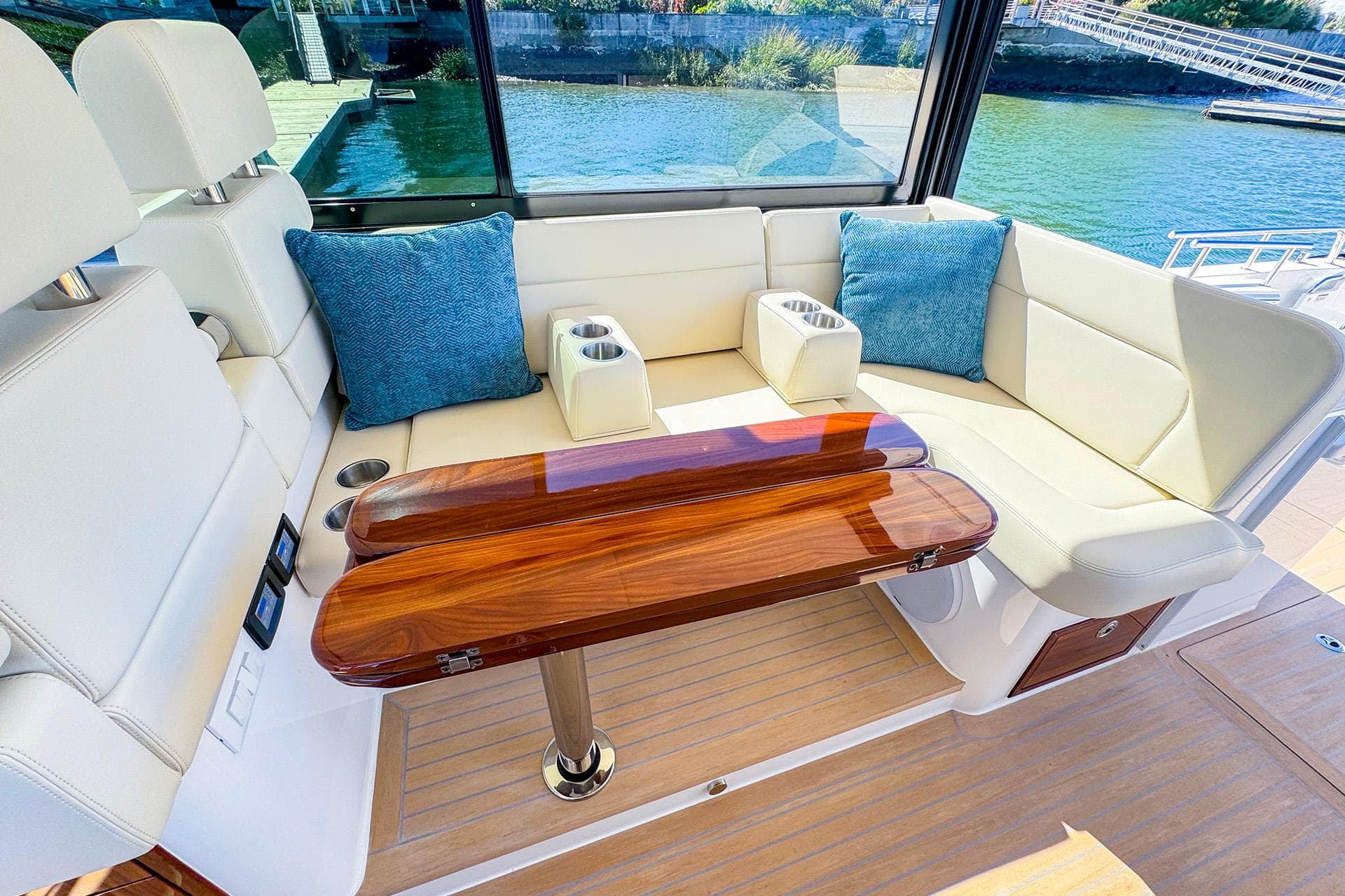 Luxurious 2024 MJM 4 yacht interior with elegant seating and wooden table.
