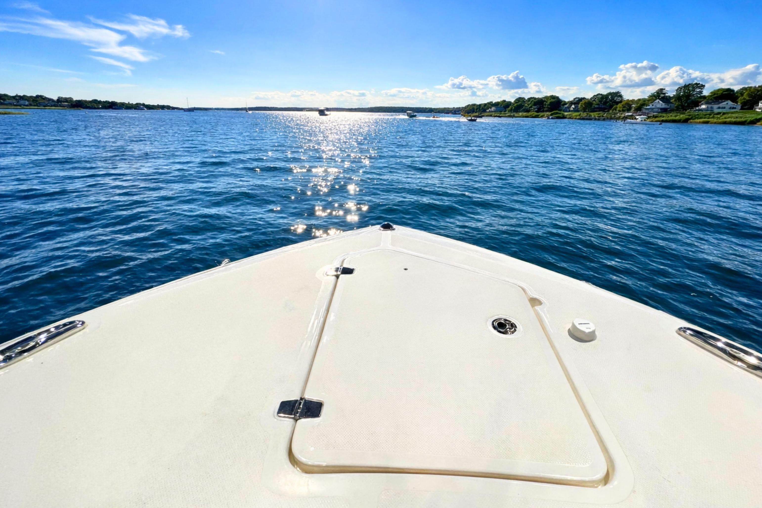 Bow view of 2026 Pursuit DC 365 Dual Console on a sunny day.
