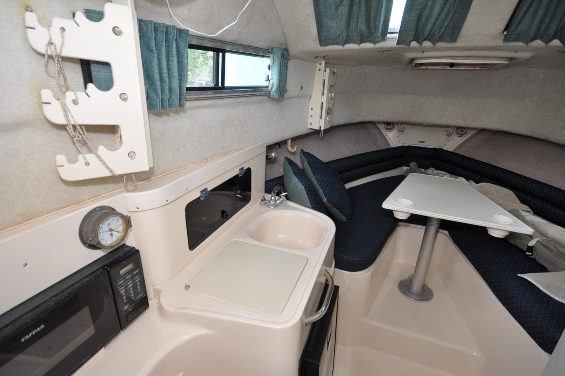 Interior of a 1997 Grady-White Marlin 300 boat with kitchenette and seating area.