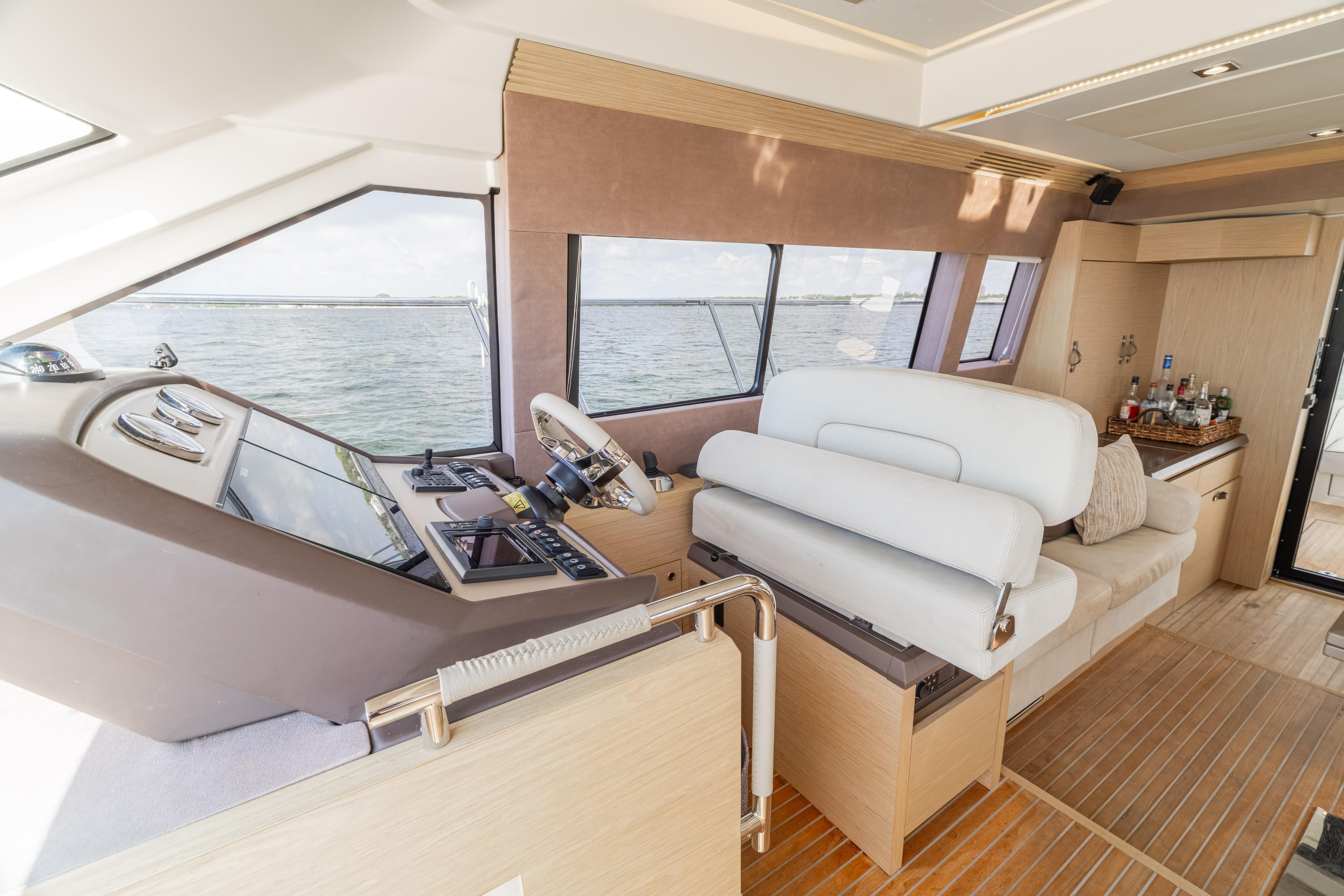 Luxurious interior of 2017 Monte Carlo Yachts MC5 with helm and seating area.