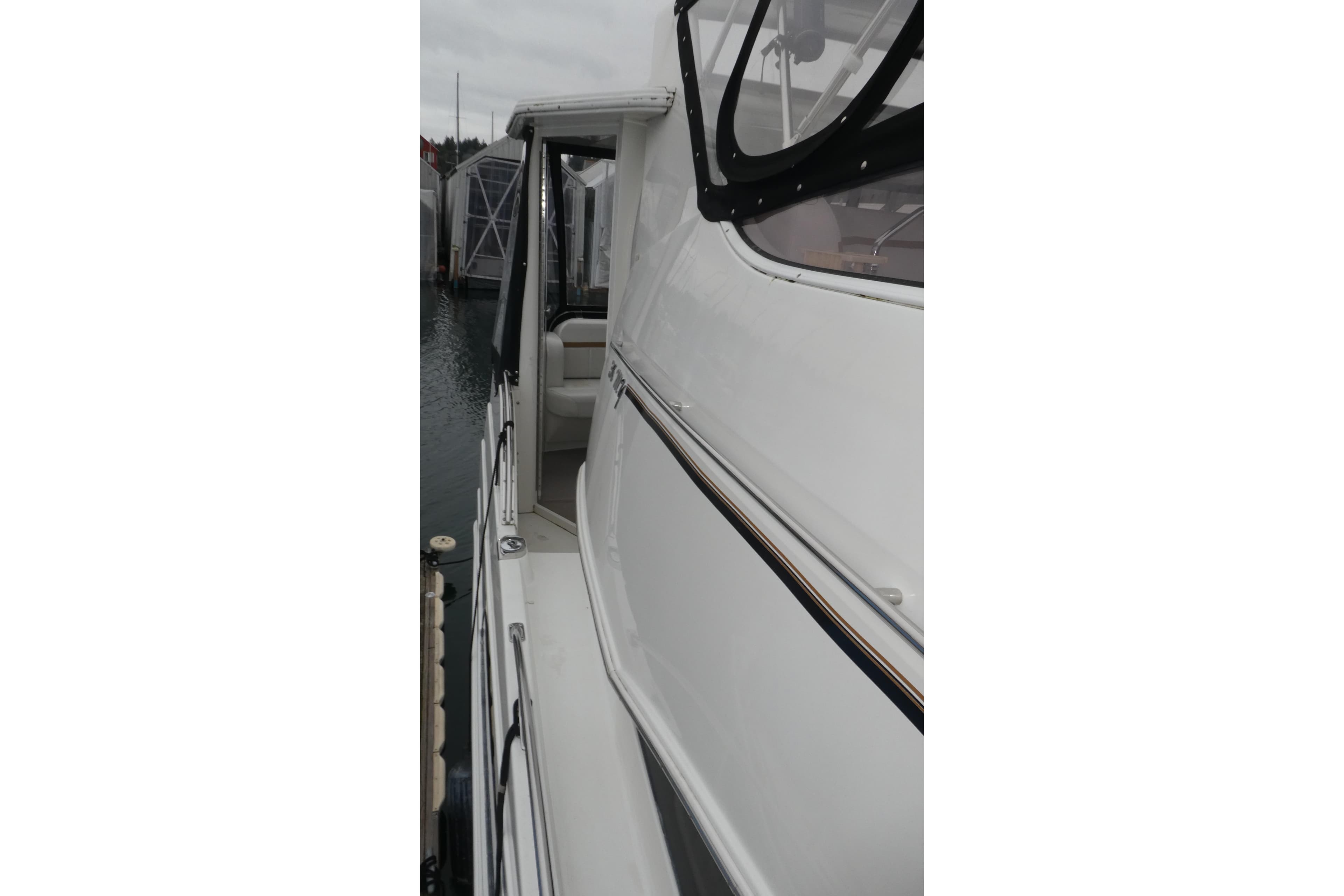 2006 Carver 366 Motor Yacht docked, showcasing sleek white exterior and side view.